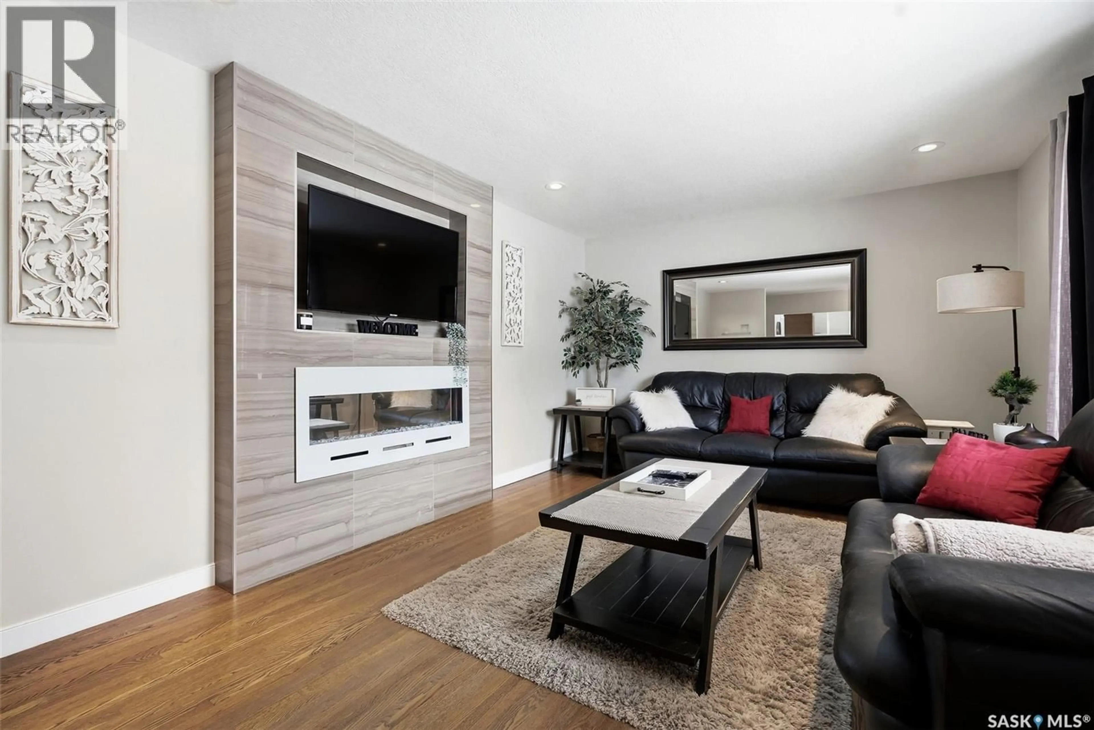 Living room with furniture, wood/laminate floor for 25 CHINOOK ROAD, Regina Saskatchewan S4S5C3