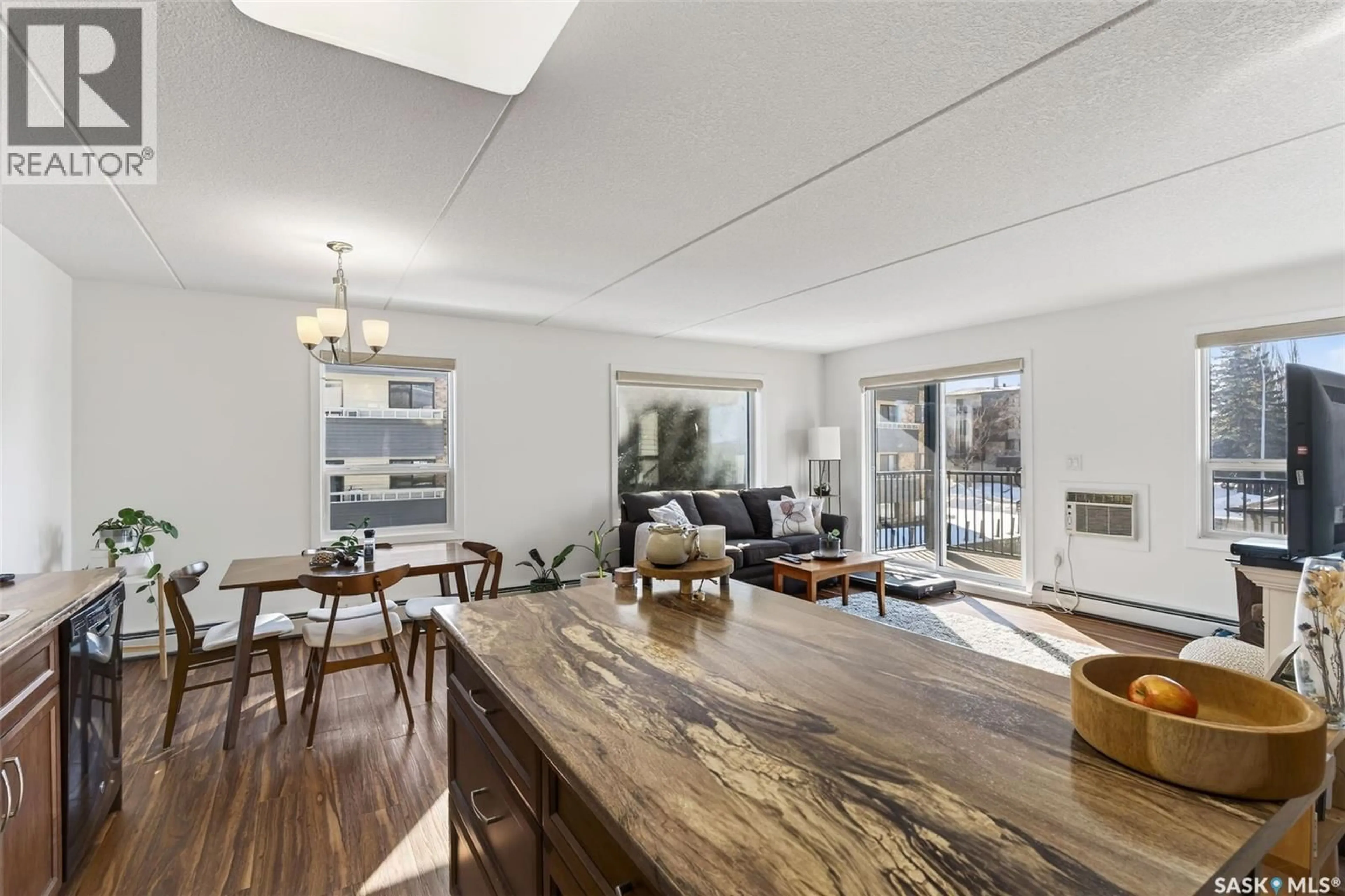 Open concept kitchen, wood/laminate floor for 208 - 2761 WOODBRIDGE DRIVE, Prince Albert Saskatchewan S6V3Z9