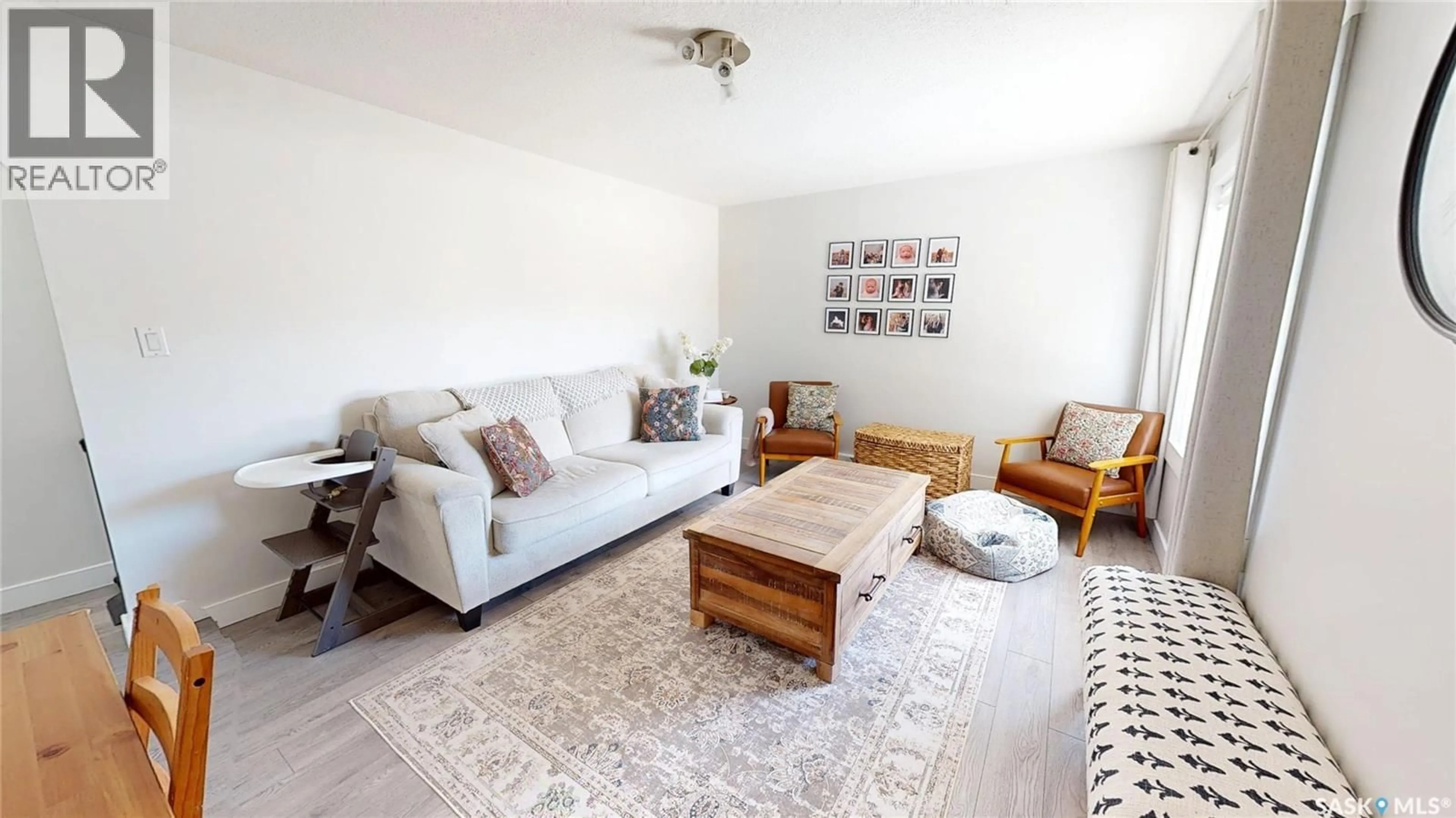 Living room with furniture, wood/laminate floor for 813 CARLTON STREET, Moosomin Saskatchewan S0G3N0