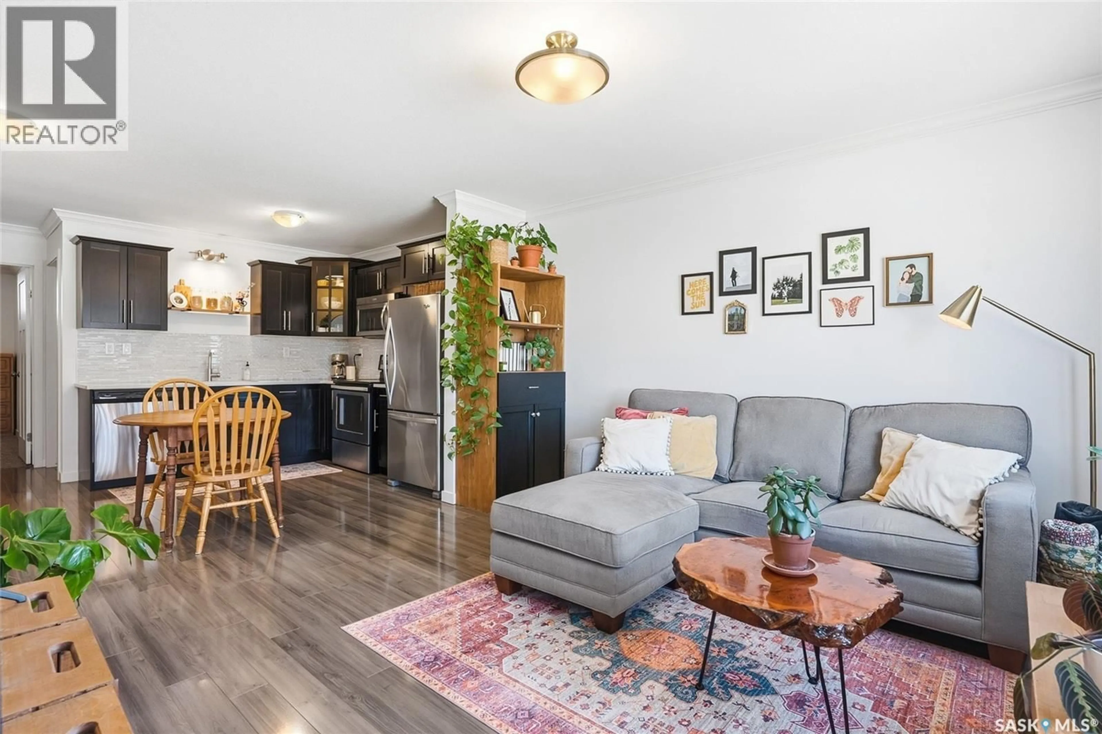 Living room with furniture, wood/laminate floor for 343 620 CORNISH ROAD, Saskatoon Saskatchewan S7T0Y3