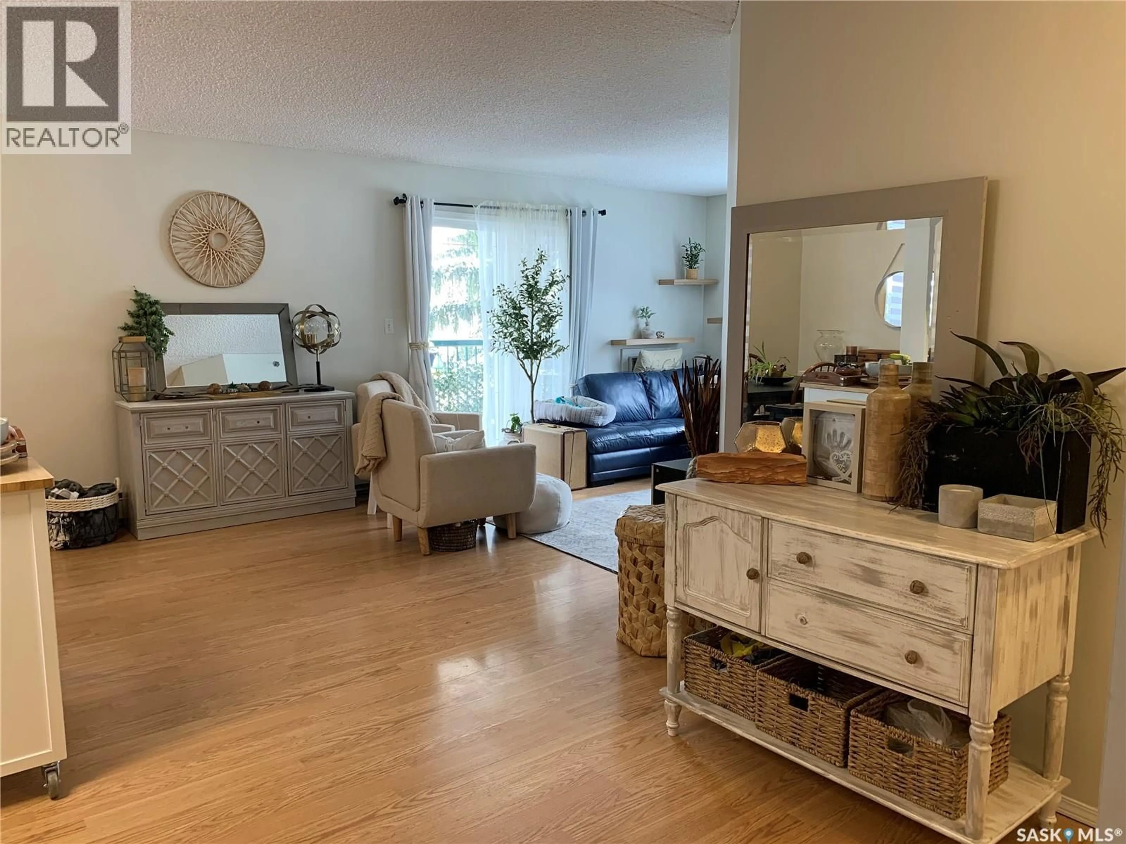 Living room with furniture, wood/laminate floor for 203 - 740 9TH STREET, Humboldt Saskatchewan S0K2A0