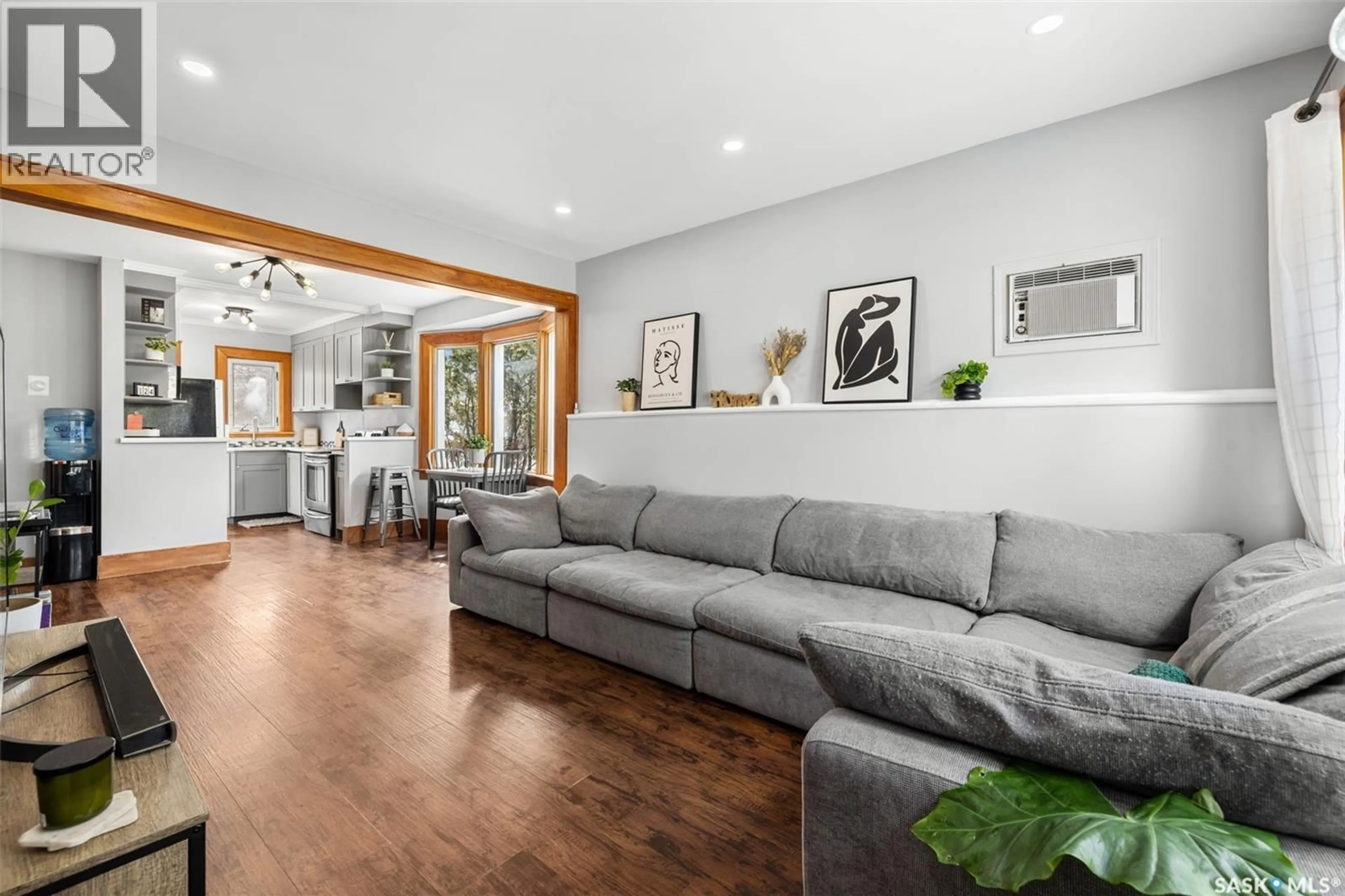 Living room with furniture, wood/laminate floor for 3637 VICTORIA AVENUE, Regina Saskatchewan S4T1M4