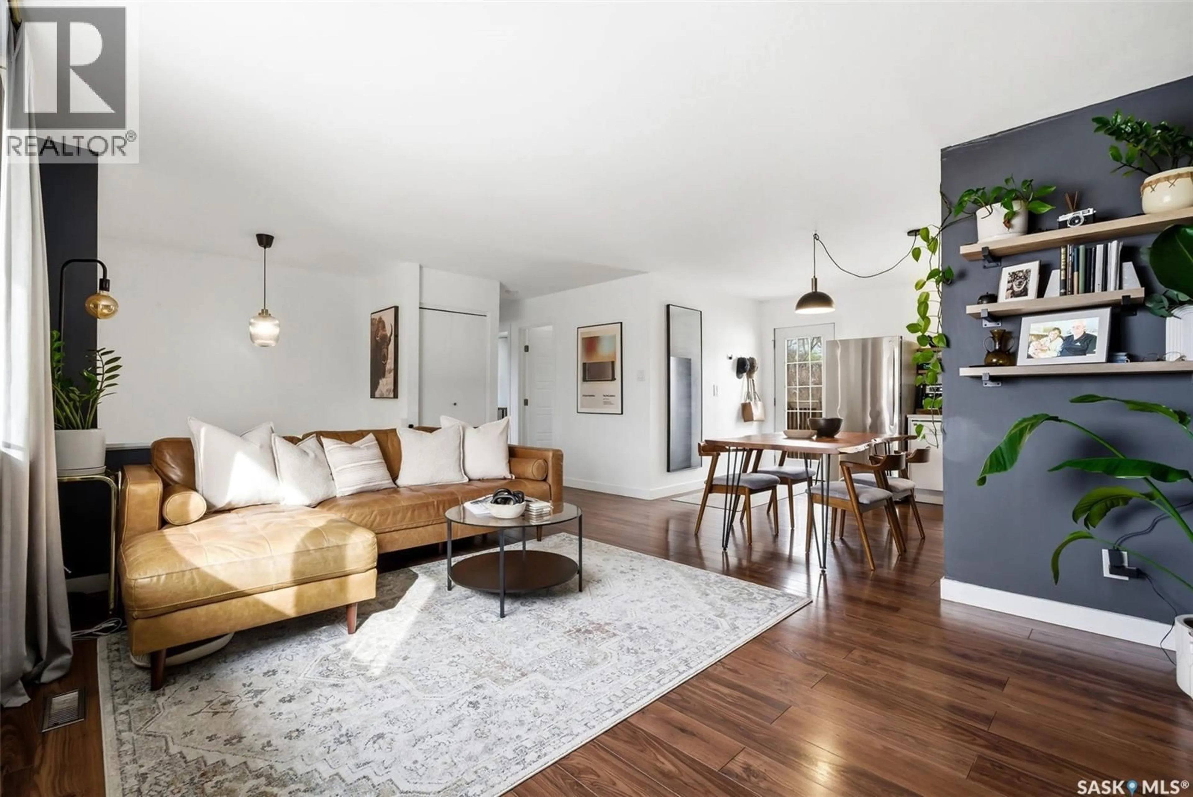 Living room with furniture, wood/laminate floor for 180 TREMAINE AVENUE, Regina Saskatchewan S4R6S6