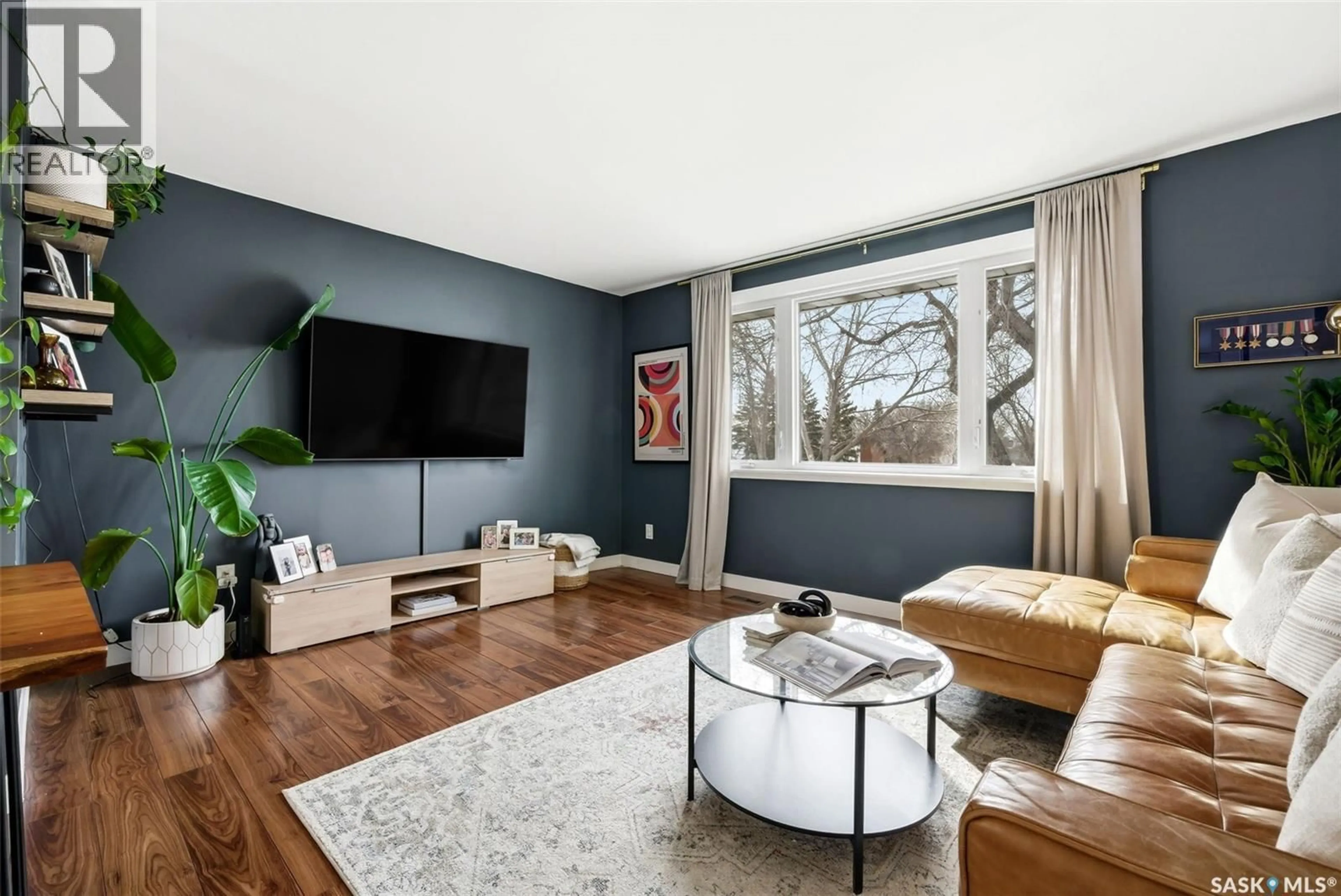 Living room with furniture, wood/laminate floor for 180 TREMAINE AVENUE, Regina Saskatchewan S4R6S6