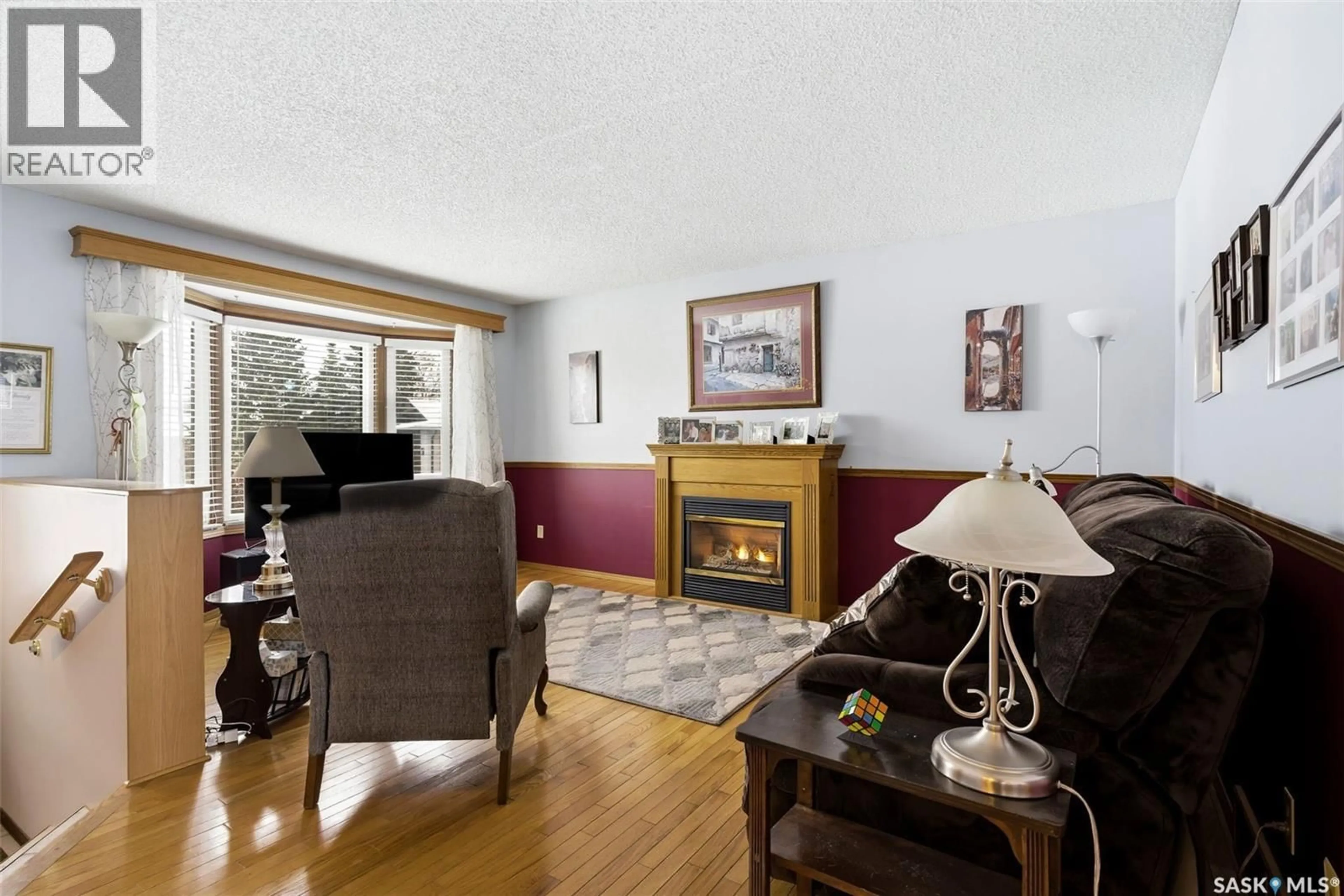 Living room with furniture, wood/laminate floor for 7322 CRIBBS BAY, Regina Saskatchewan S4X4H3