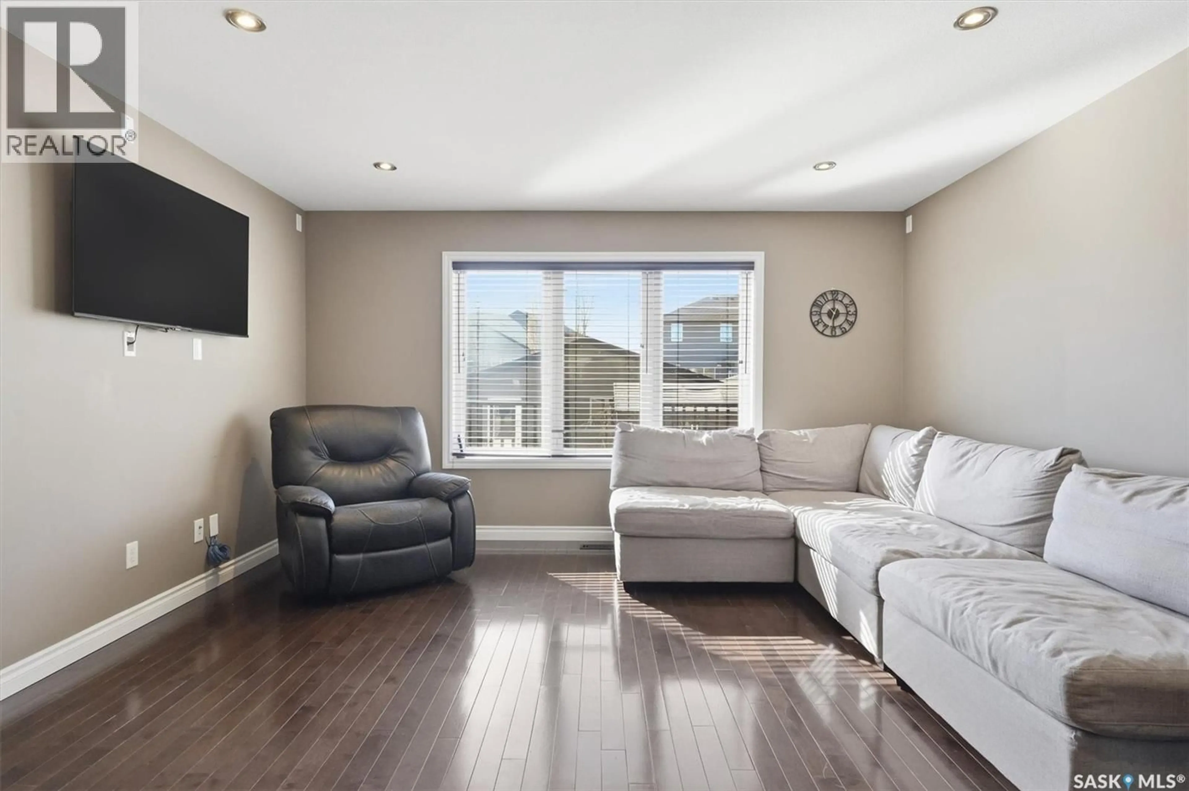 Living room with furniture, wood/laminate floor for 330 LYND LANE, Saskatoon Saskatchewan S7T0B1