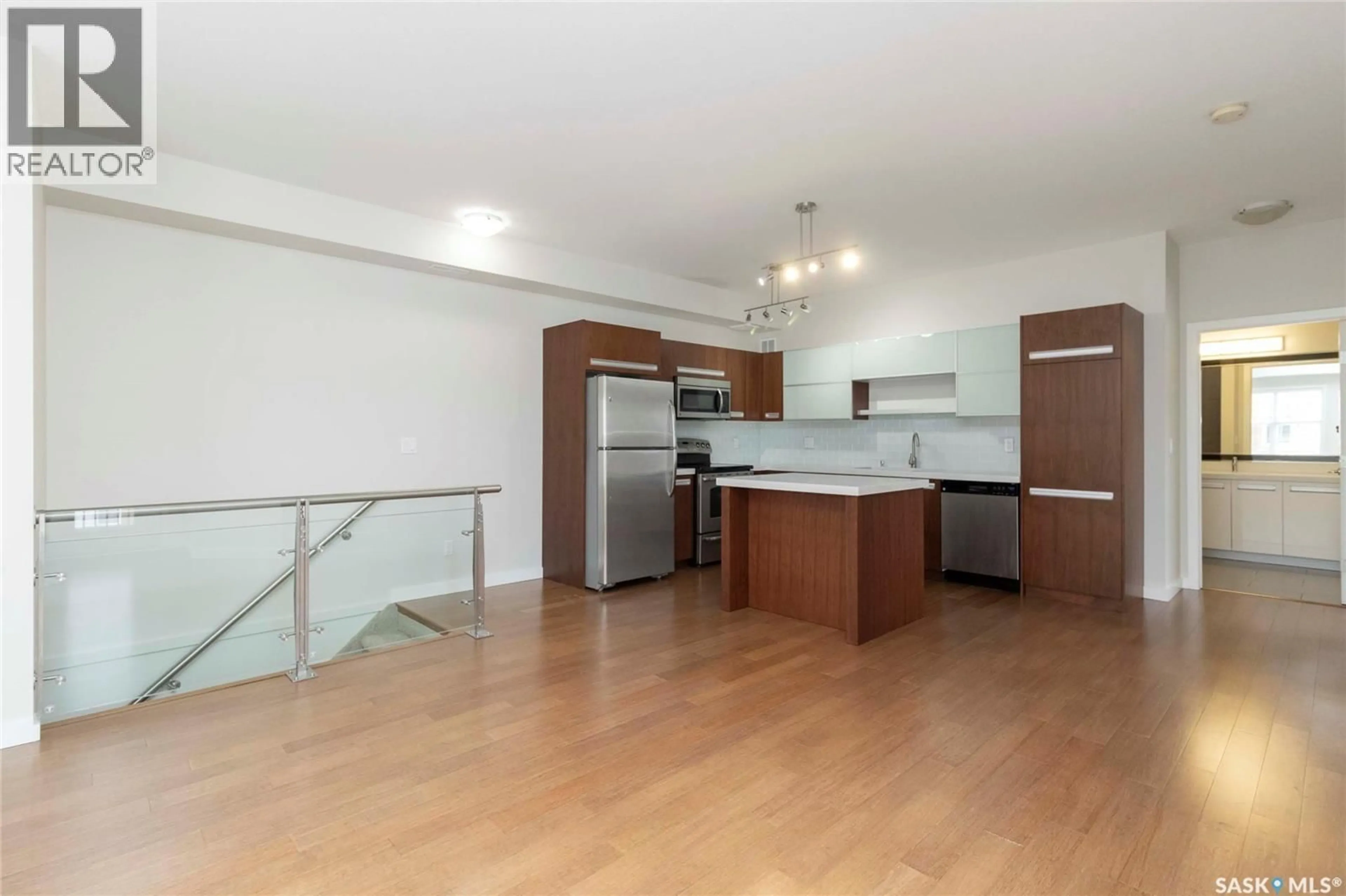 Open concept kitchen, wood/laminate floor for 1015 - 704 PATRICK CRESCENT, Saskatoon Saskatchewan S7W0M5