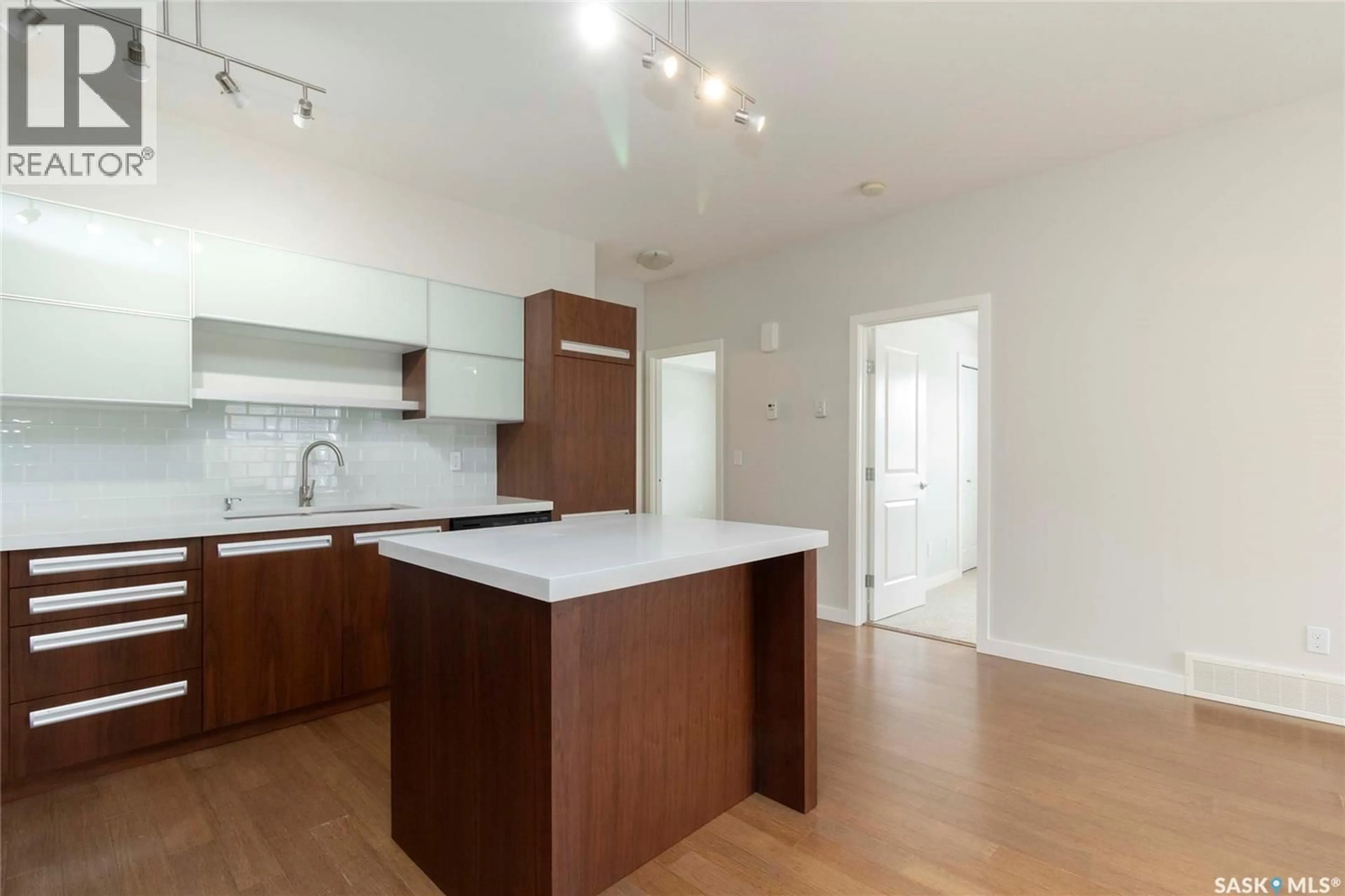 Open concept kitchen, wood/laminate floor for 1015 - 704 PATRICK CRESCENT, Saskatoon Saskatchewan S7W0M5