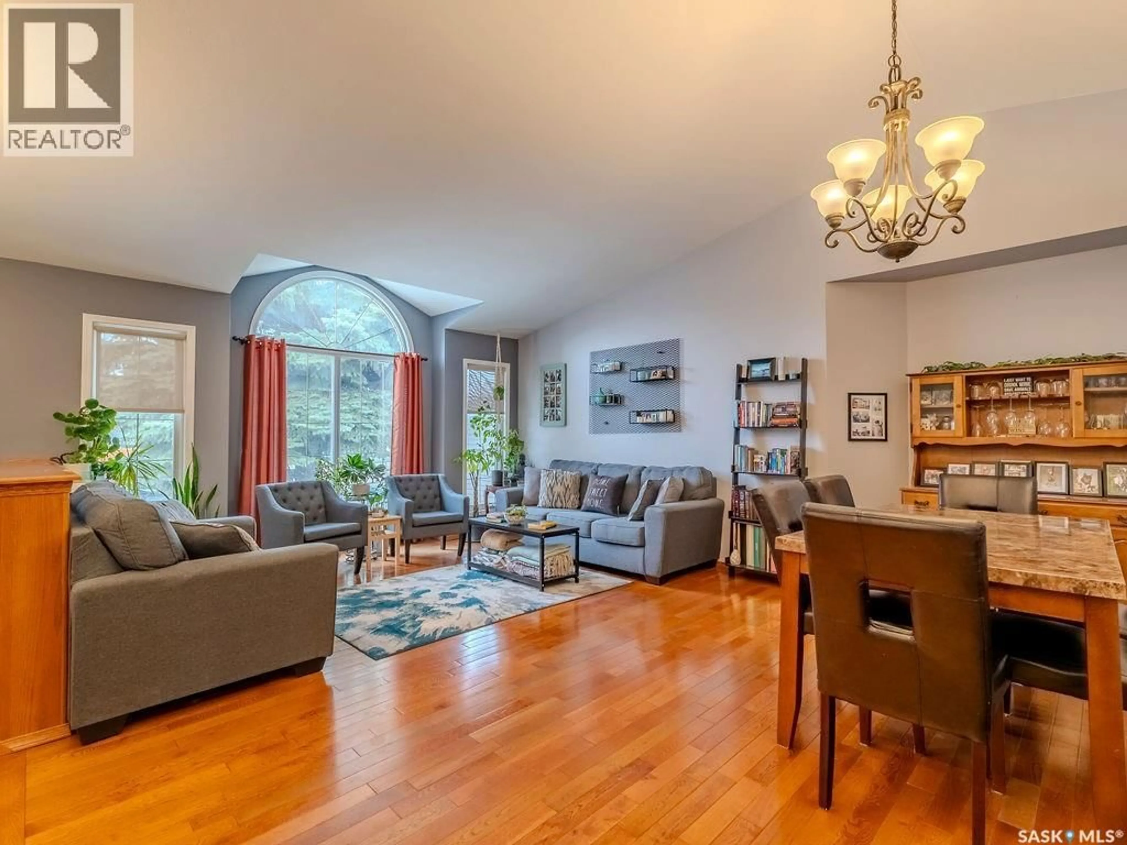 Living room with furniture, wood/laminate floor for 2306 KENDERDINE ROAD, Saskatoon Saskatchewan S7N4J5