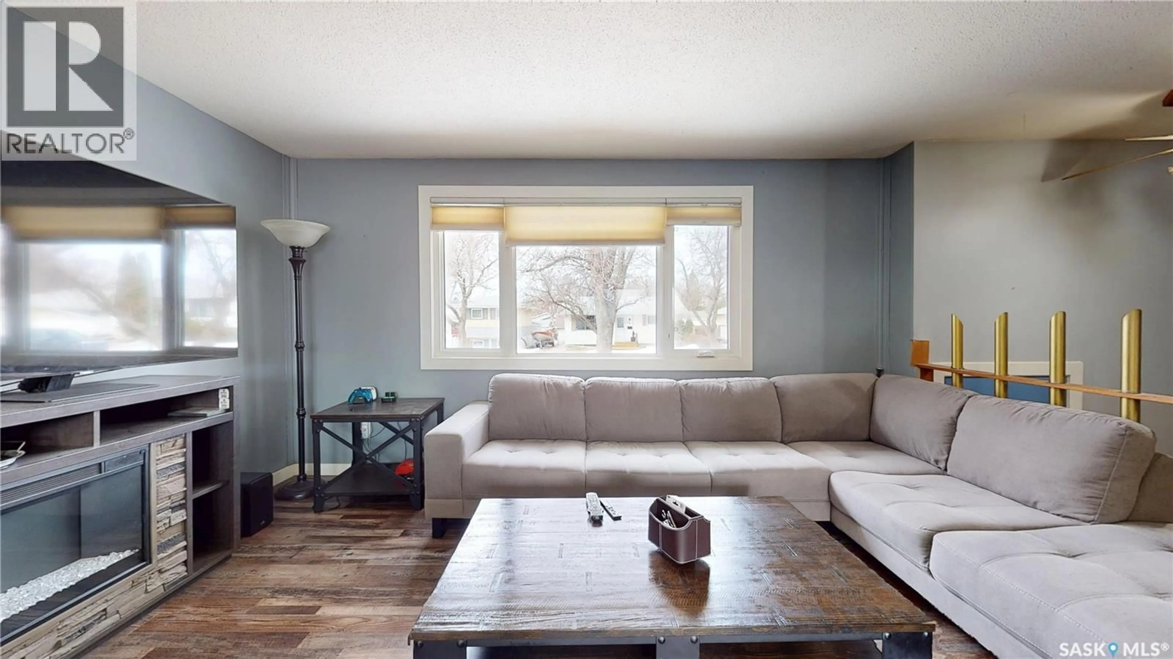 Living room with furniture, wood/laminate floor for 115 STRAUB STREET, Regina Saskatchewan S4T6R7