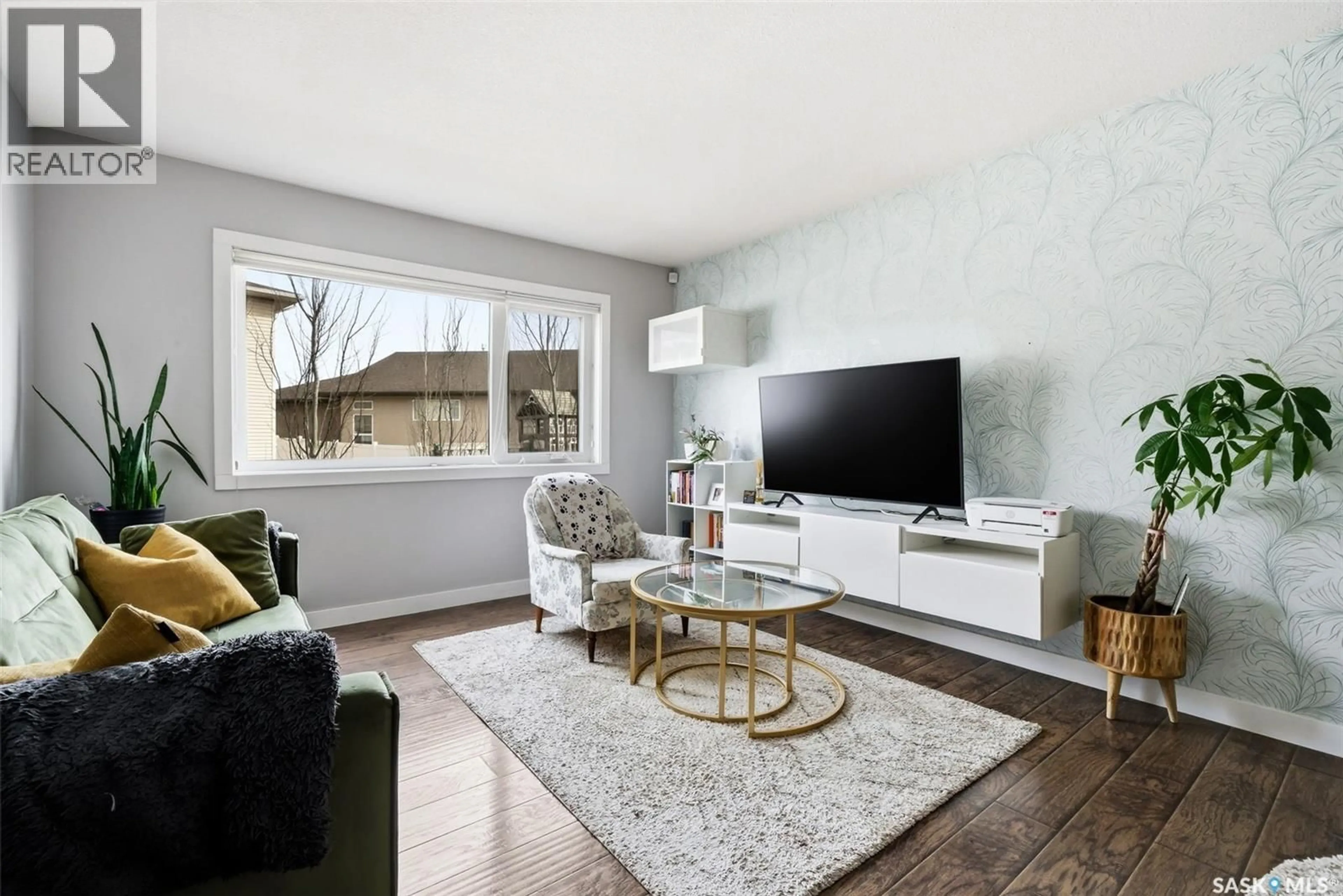 Living room with furniture, wood/laminate floor for 12 - 5301 BEACON DRIVE, Regina Saskatchewan S4W0R6