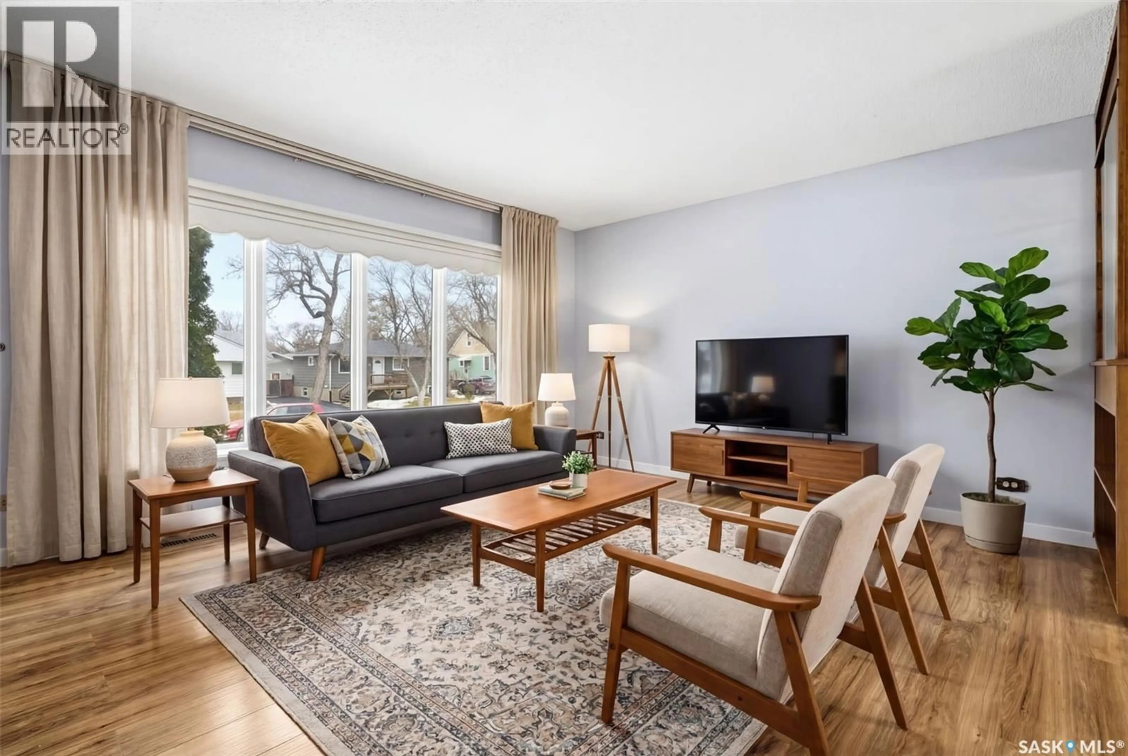 Living room with furniture, wood/laminate floor for E - 615 MULLIN AVENUE, Regina Saskatchewan S4N1E1