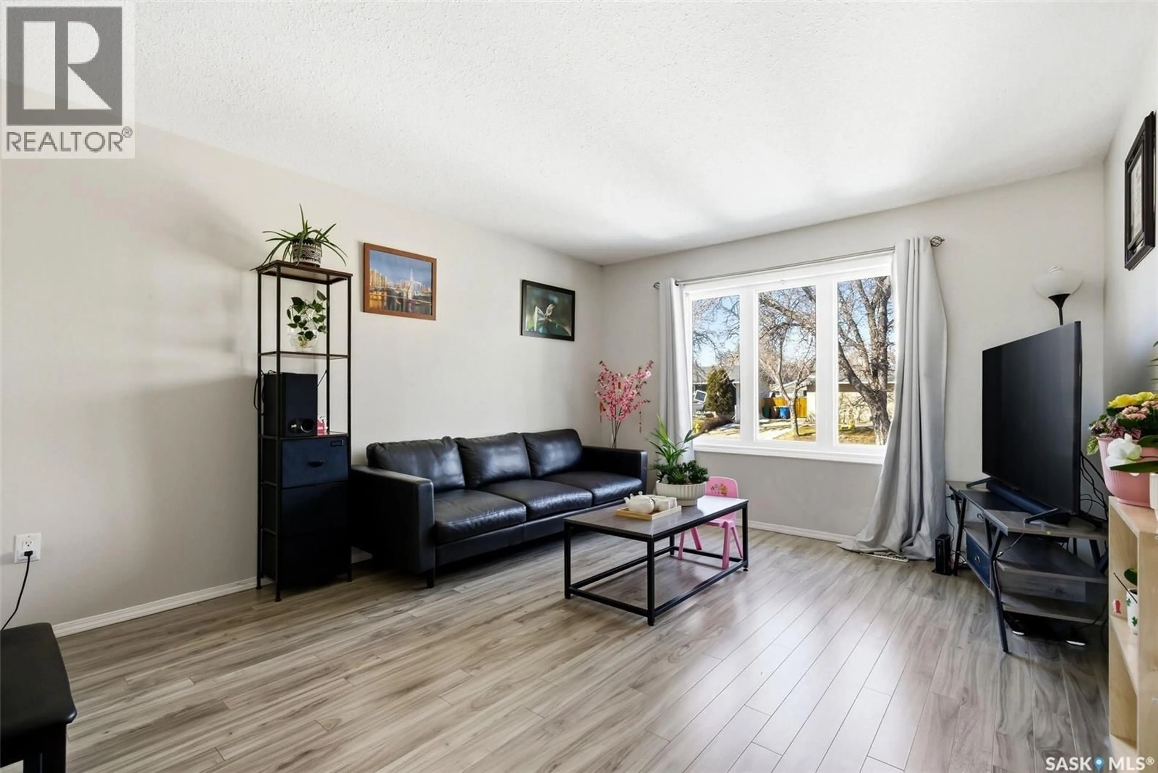 Living room with furniture, wood/laminate floor for 55 SCHNEIDER CRESCENT, Regina Saskatchewan S4P4B7