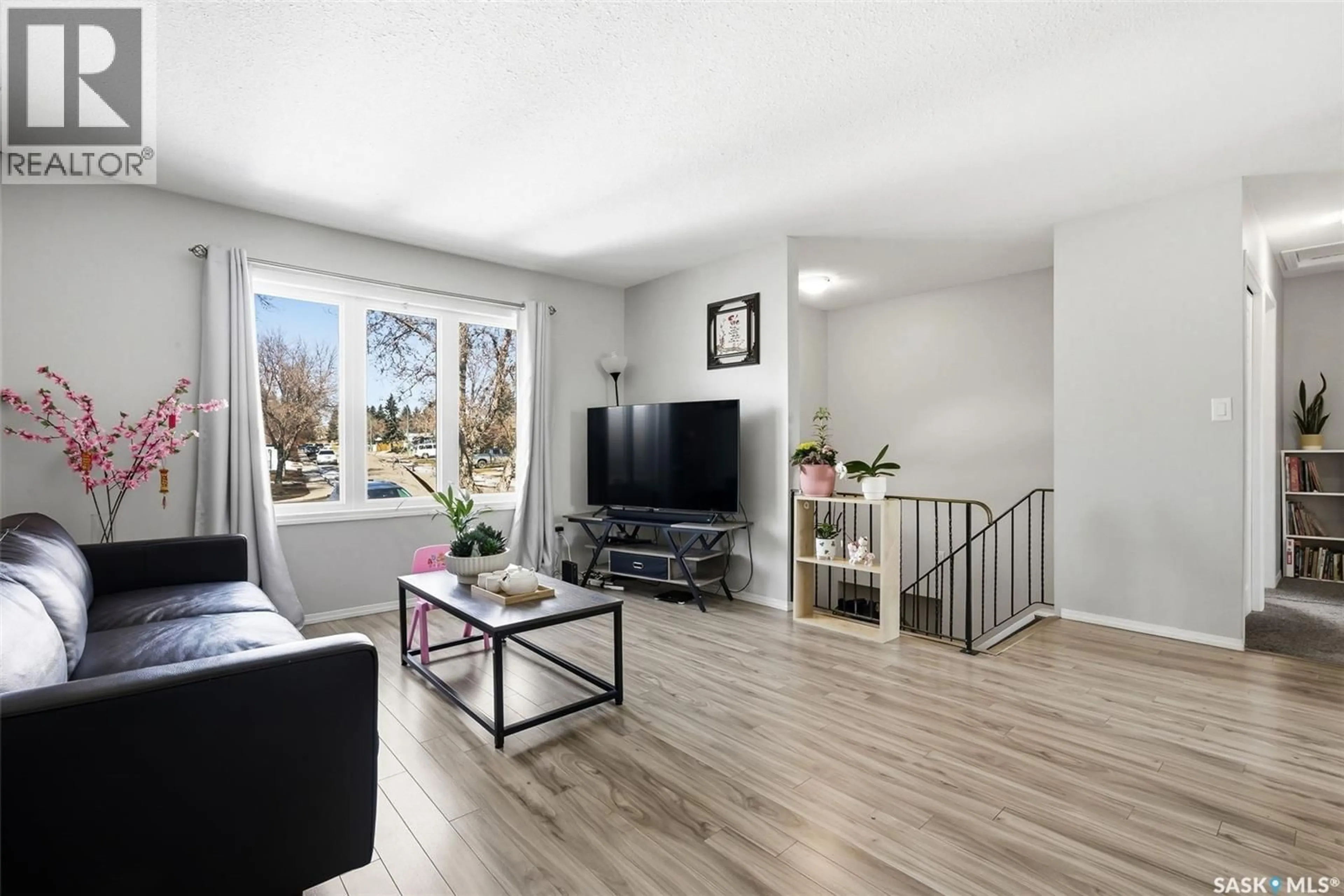 Living room with furniture, wood/laminate floor for 55 SCHNEIDER CRESCENT, Regina Saskatchewan S4P4B7