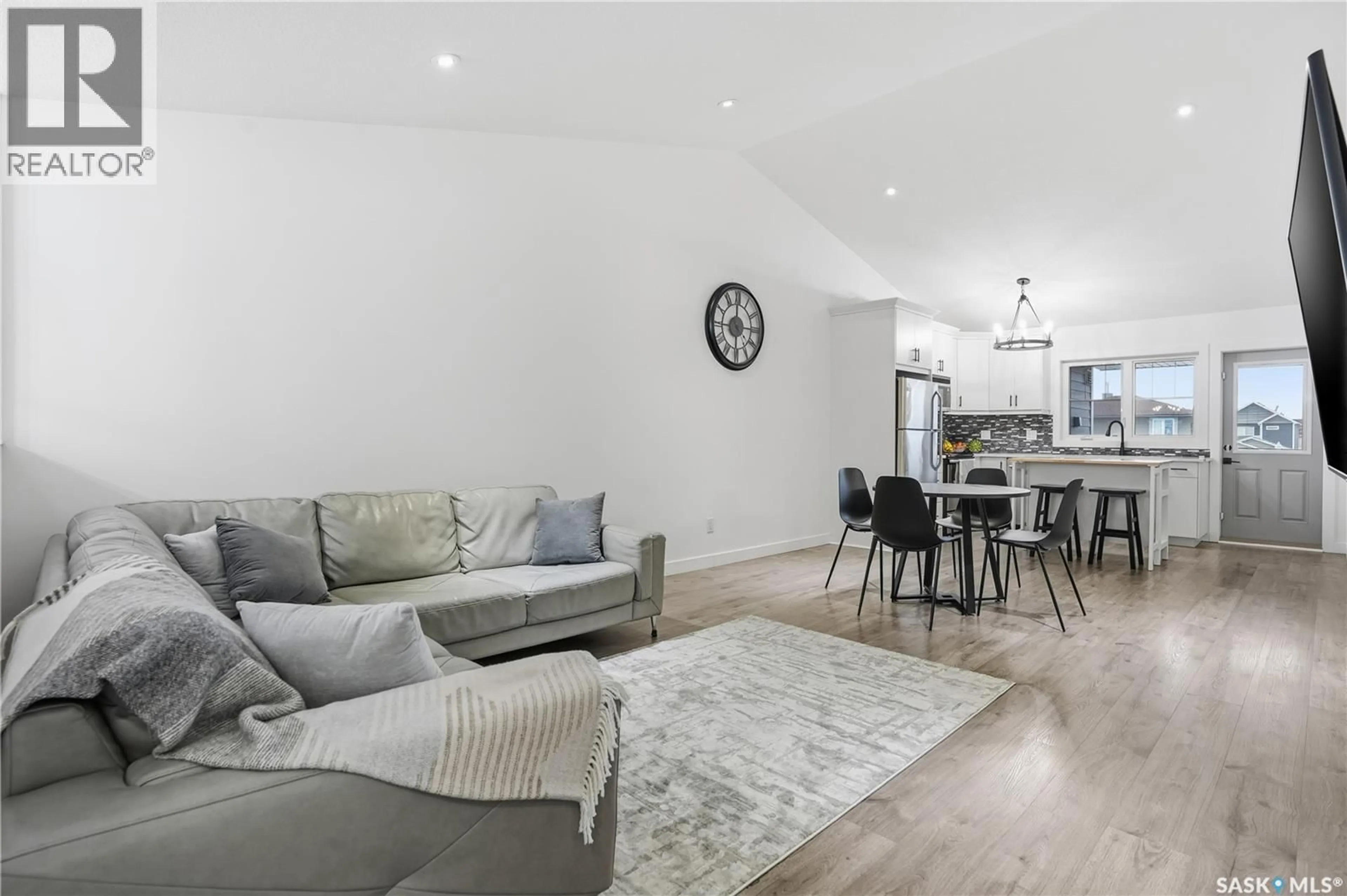 Living room with furniture, wood/laminate floor for E - 4159 GREEN APPLE DRIVE, Regina Saskatchewan S4V1S1