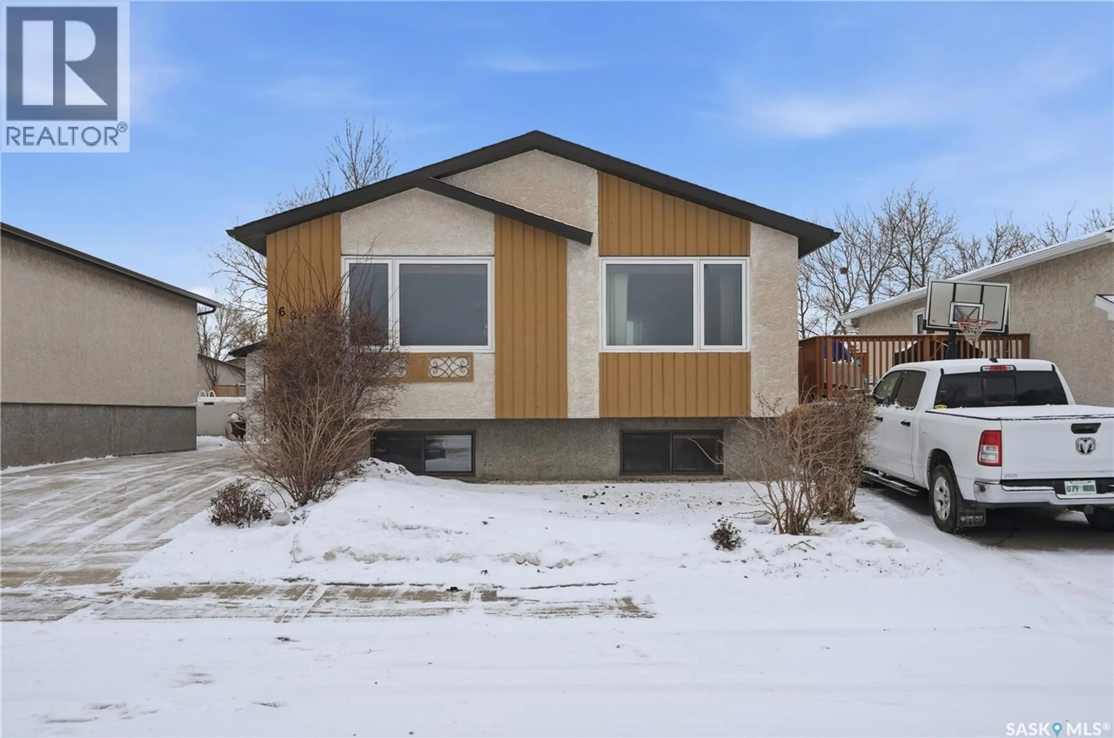 Home with vinyl exterior material, street for 6914 CUNNINGHAM DRIVE, Regina Saskatchewan S4X3V6