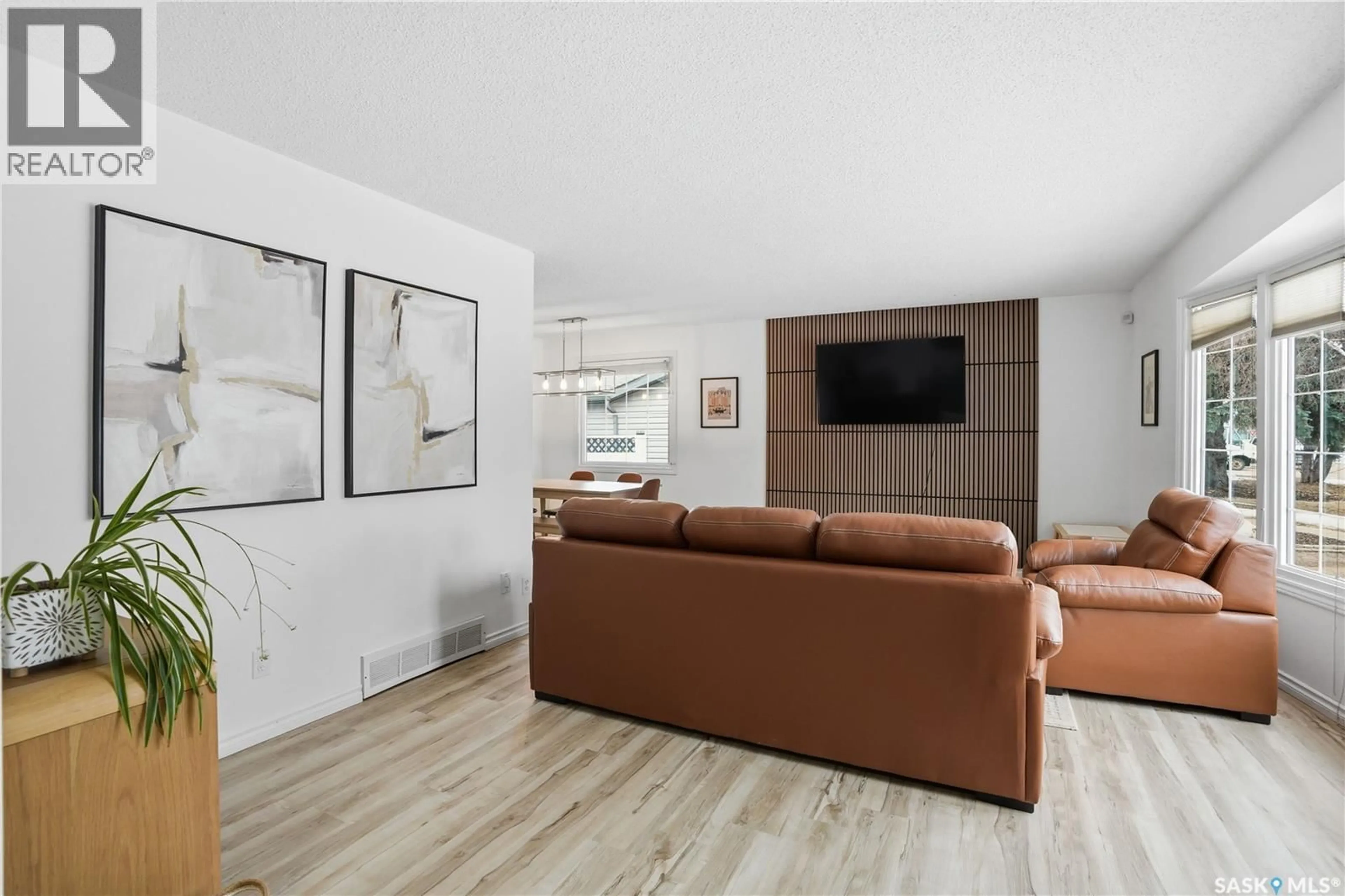 Living room with furniture, wood/laminate floor for 118 APPLEBY DRIVE, Saskatoon Saskatchewan S7M4B5