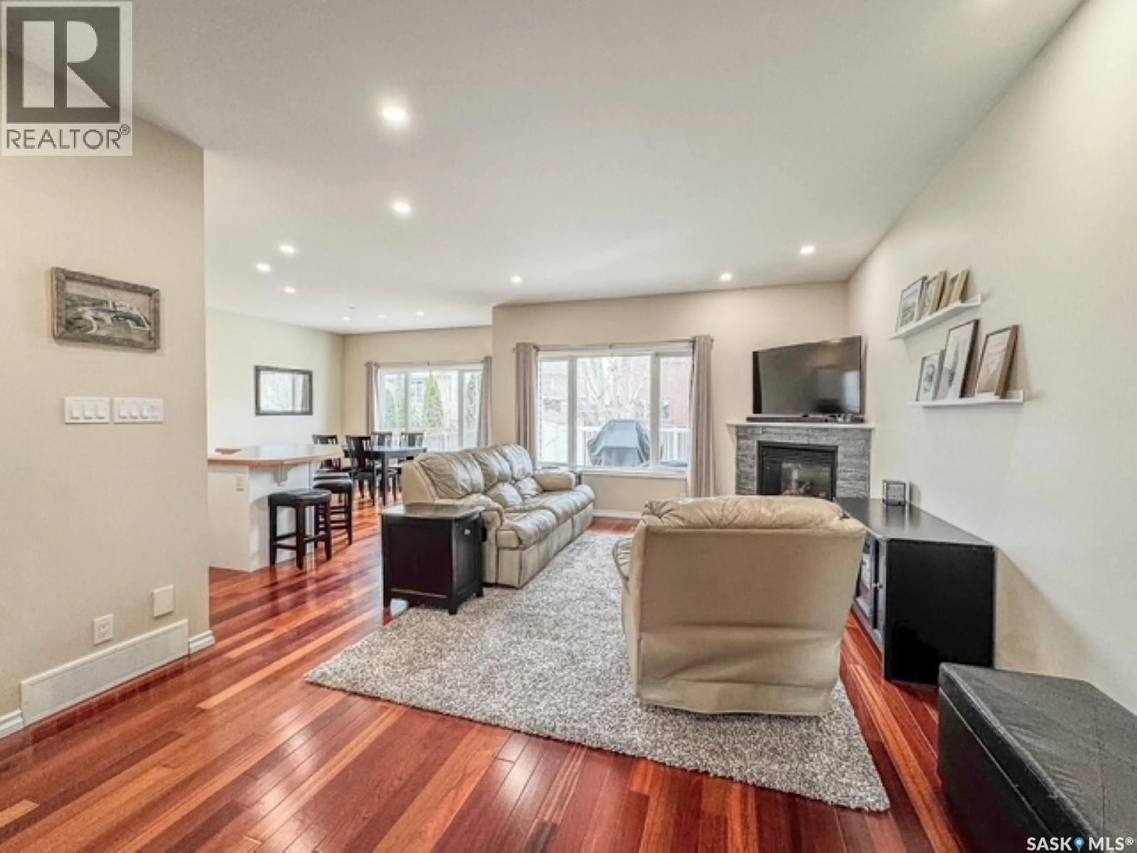 Living room with furniture, wood/laminate floor for 520 PALLISER DRIVE, Swift Current Saskatchewan S9H5C5