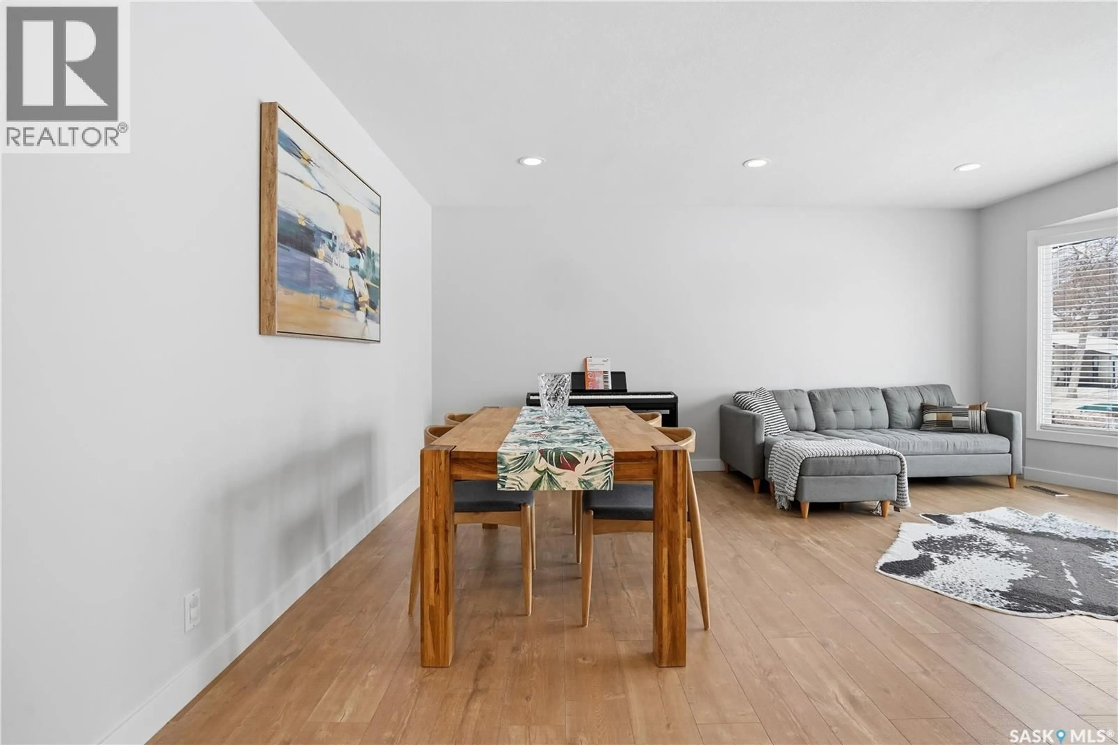 Living room with furniture, wood/laminate floor for 6131 7TH AVENUE, Regina Saskatchewan S4T6Y9