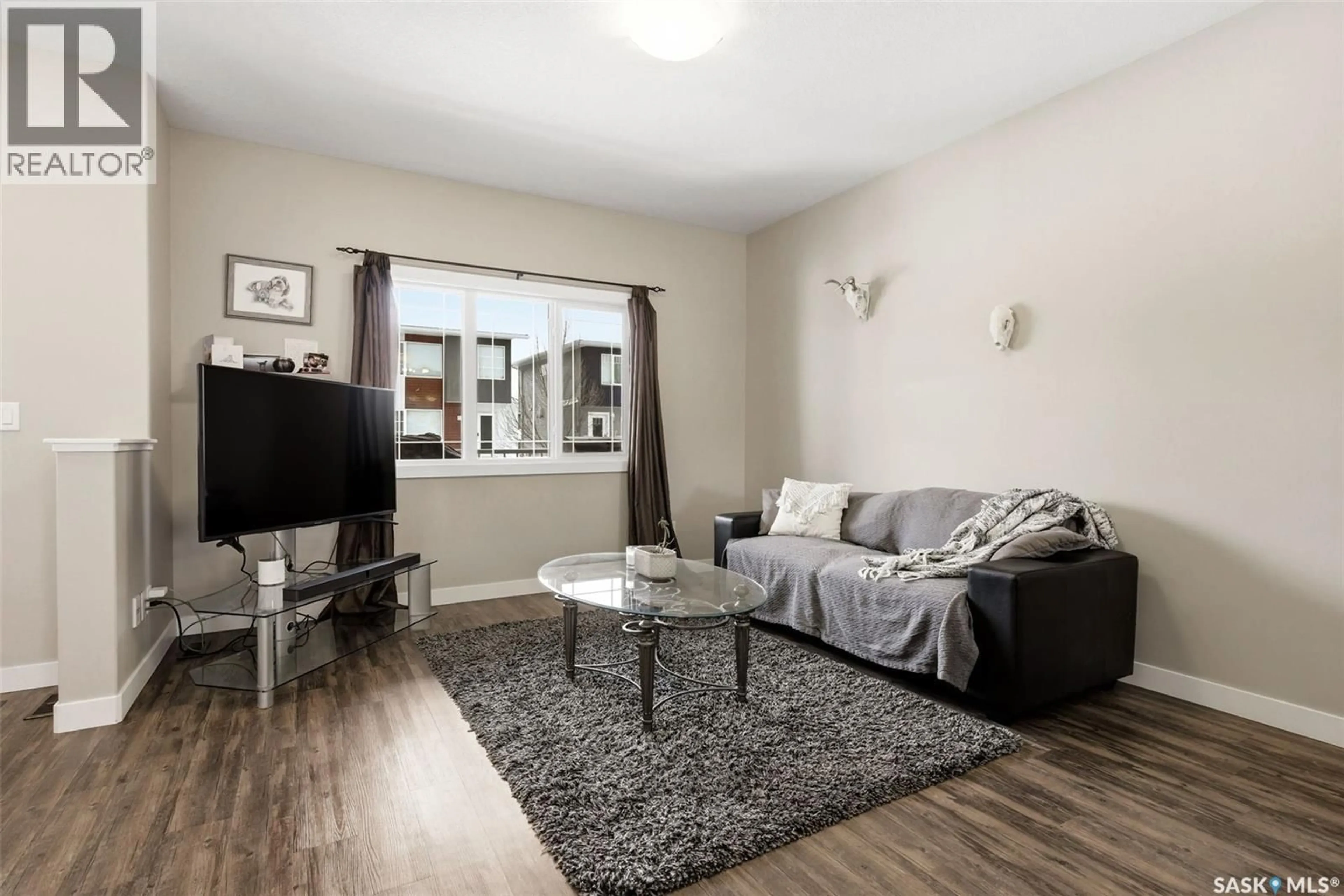 Living room with furniture, wood/laminate floor for 5610 CAMPLING AVENUE, Regina Saskatchewan S4W0P7