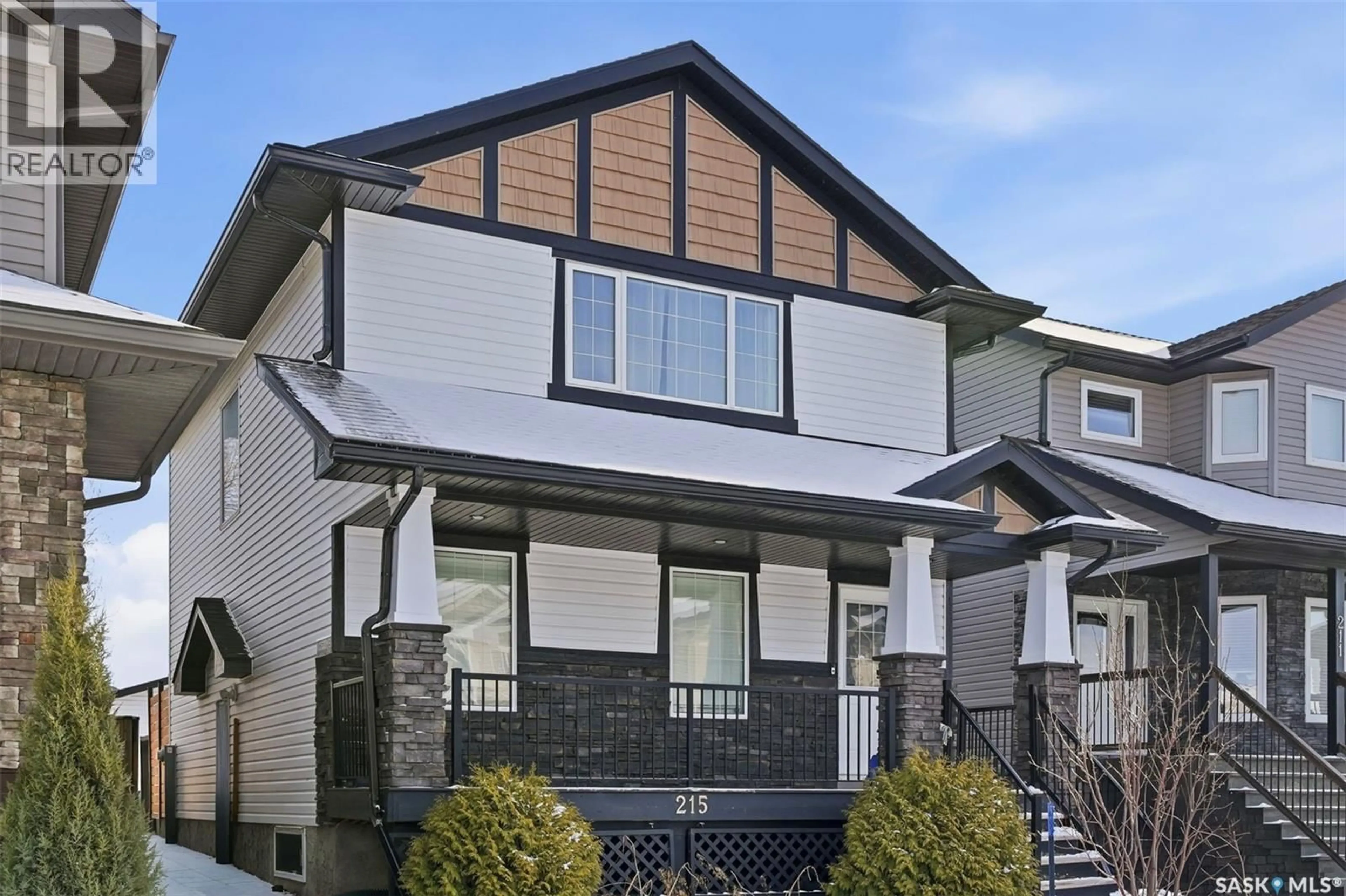 Home with vinyl exterior material, street for 215 WYANT LANE, Saskatoon Saskatchewan S7W0L2