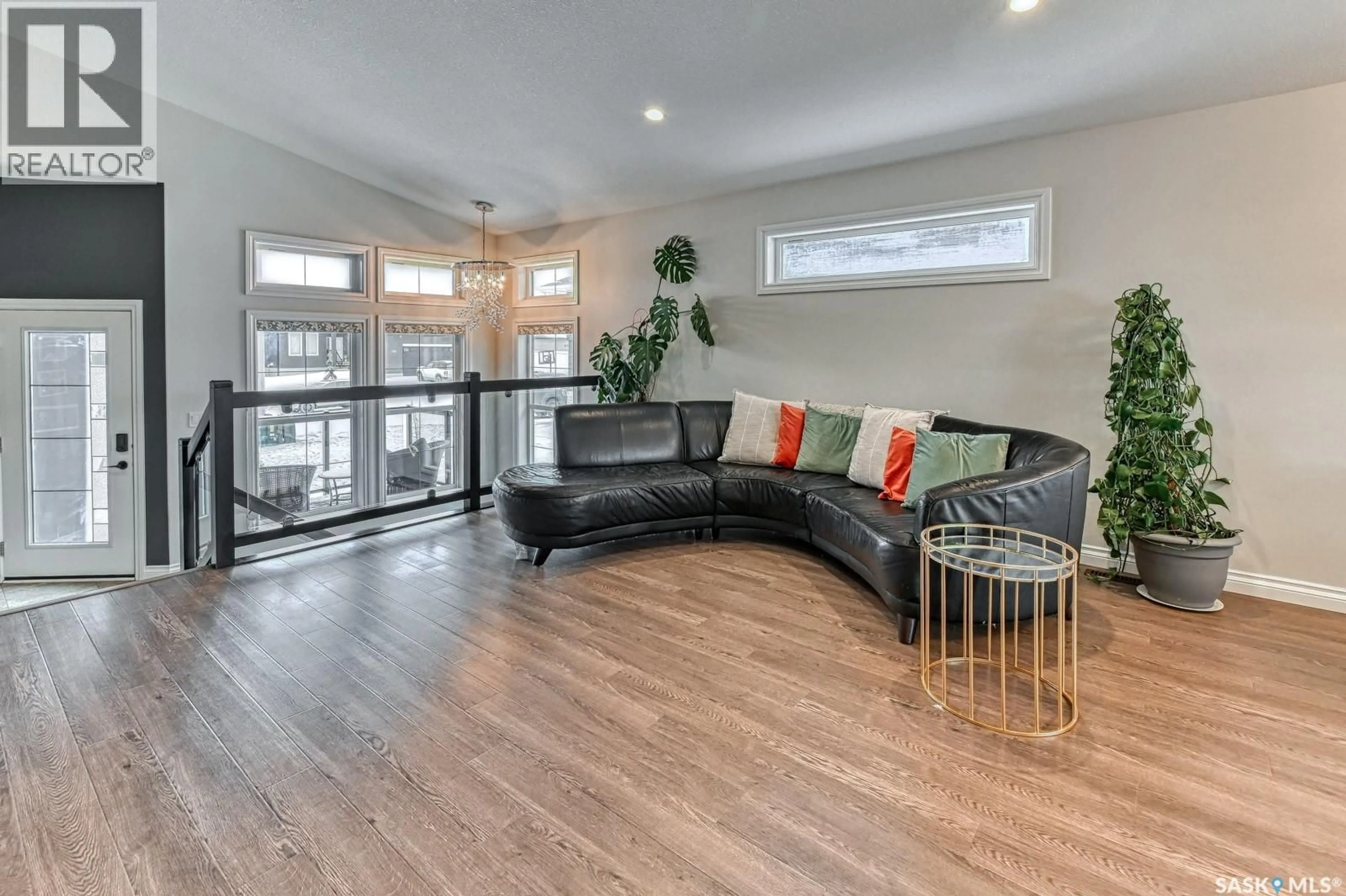 Living room with furniture, wood/laminate floor for 635 ASPEN CRESCENT, Pilot Butte Saskatchewan S0G3Z0