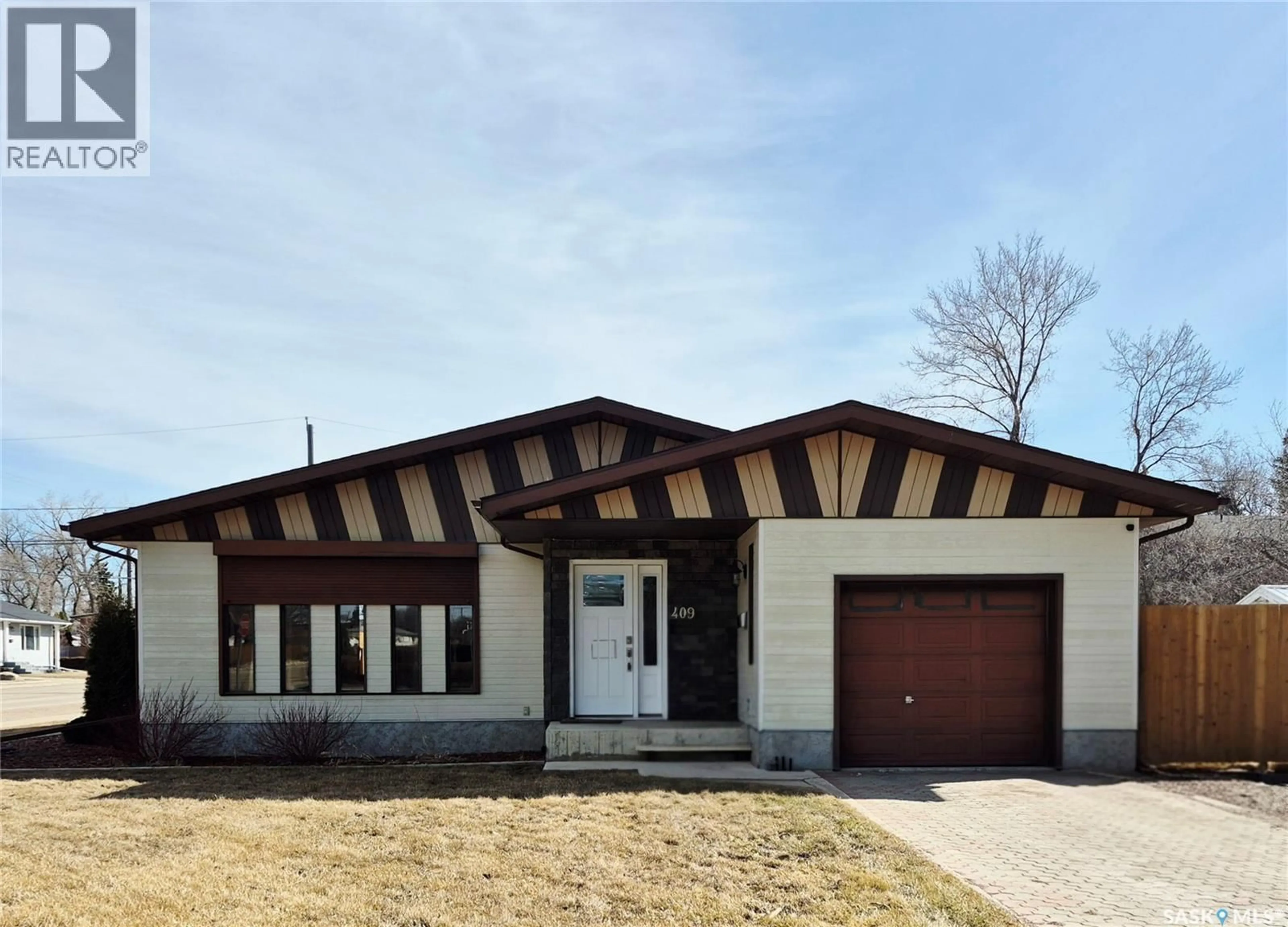 Home with brick exterior material, street for 409 5TH AVENUE, Swift Current Saskatchewan S9H3N5
