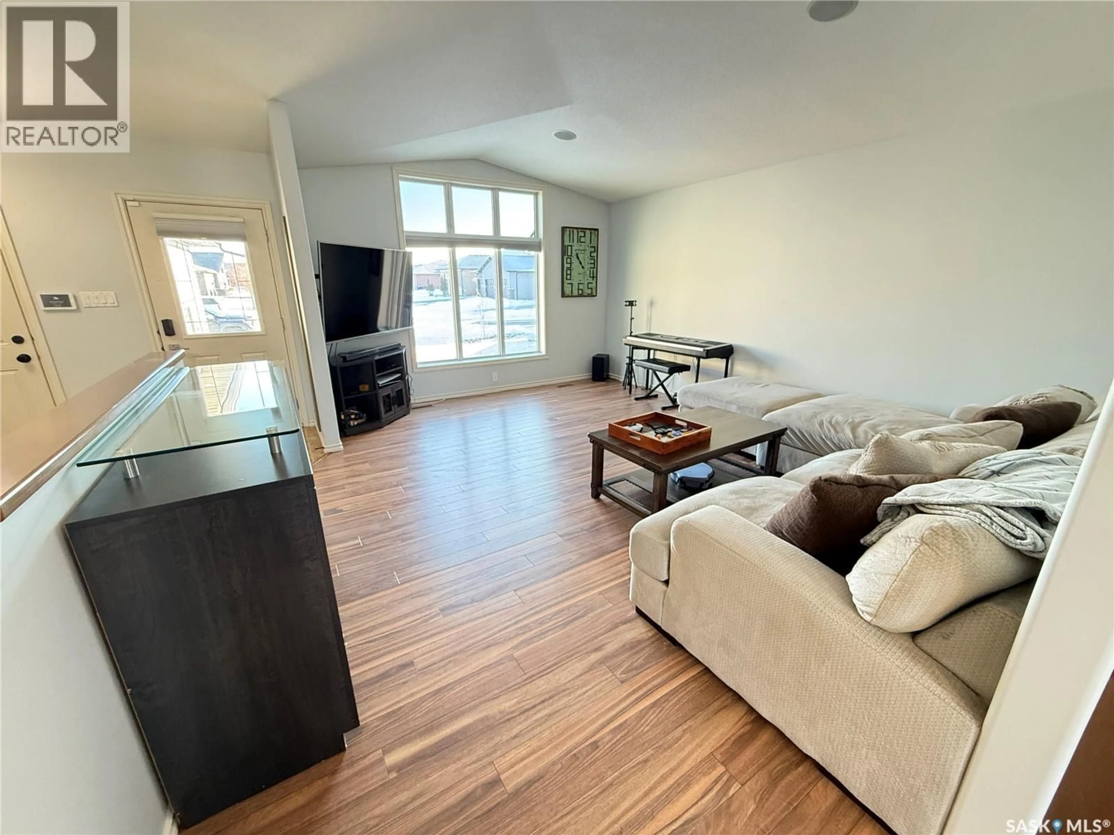 Living room with furniture, wood/laminate floor for 509 BROWN CRESCENT, Weyburn Saskatchewan S4H0M9