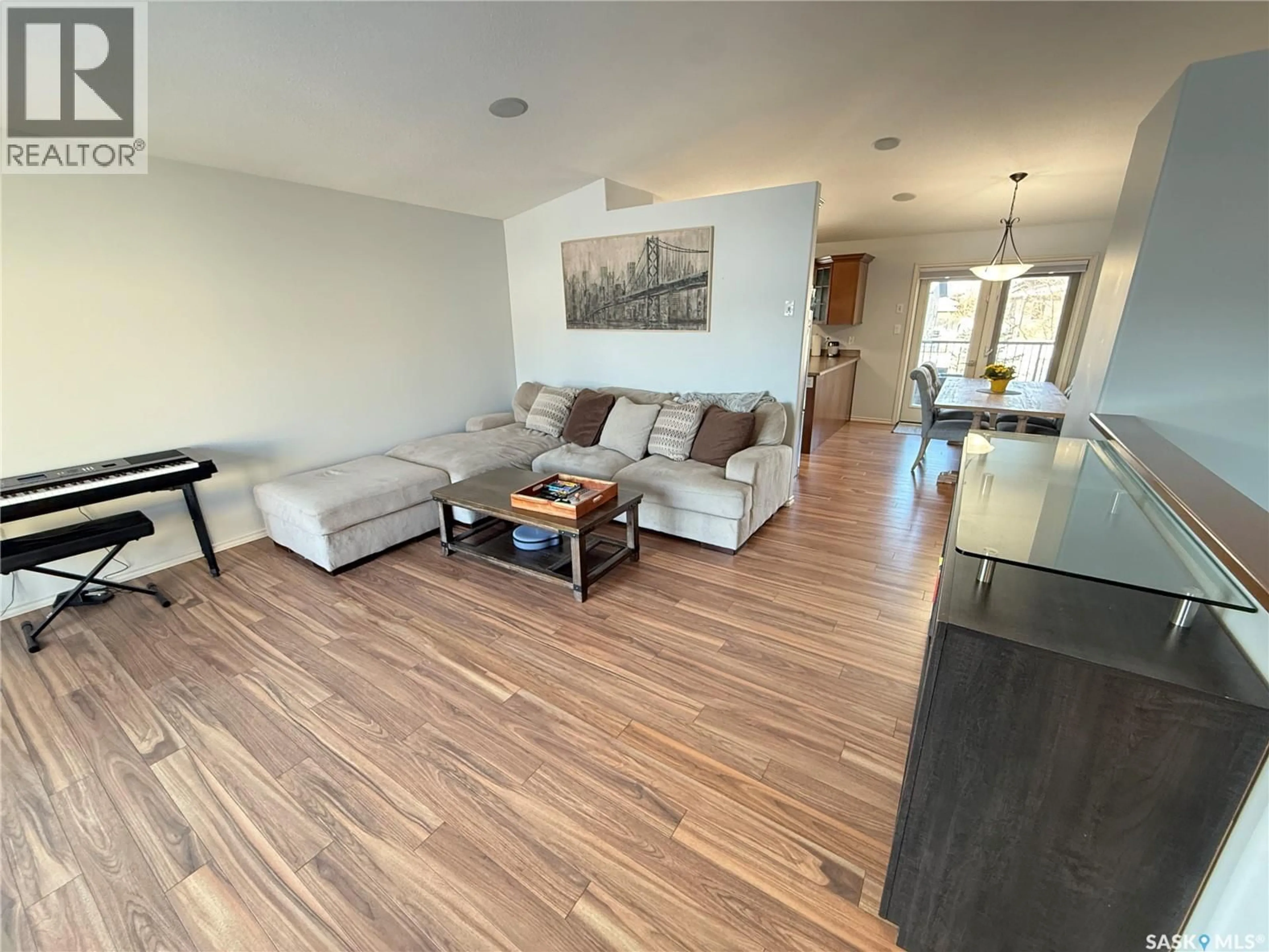 Living room with furniture, wood/laminate floor for 509 BROWN CRESCENT, Weyburn Saskatchewan S4H0M9