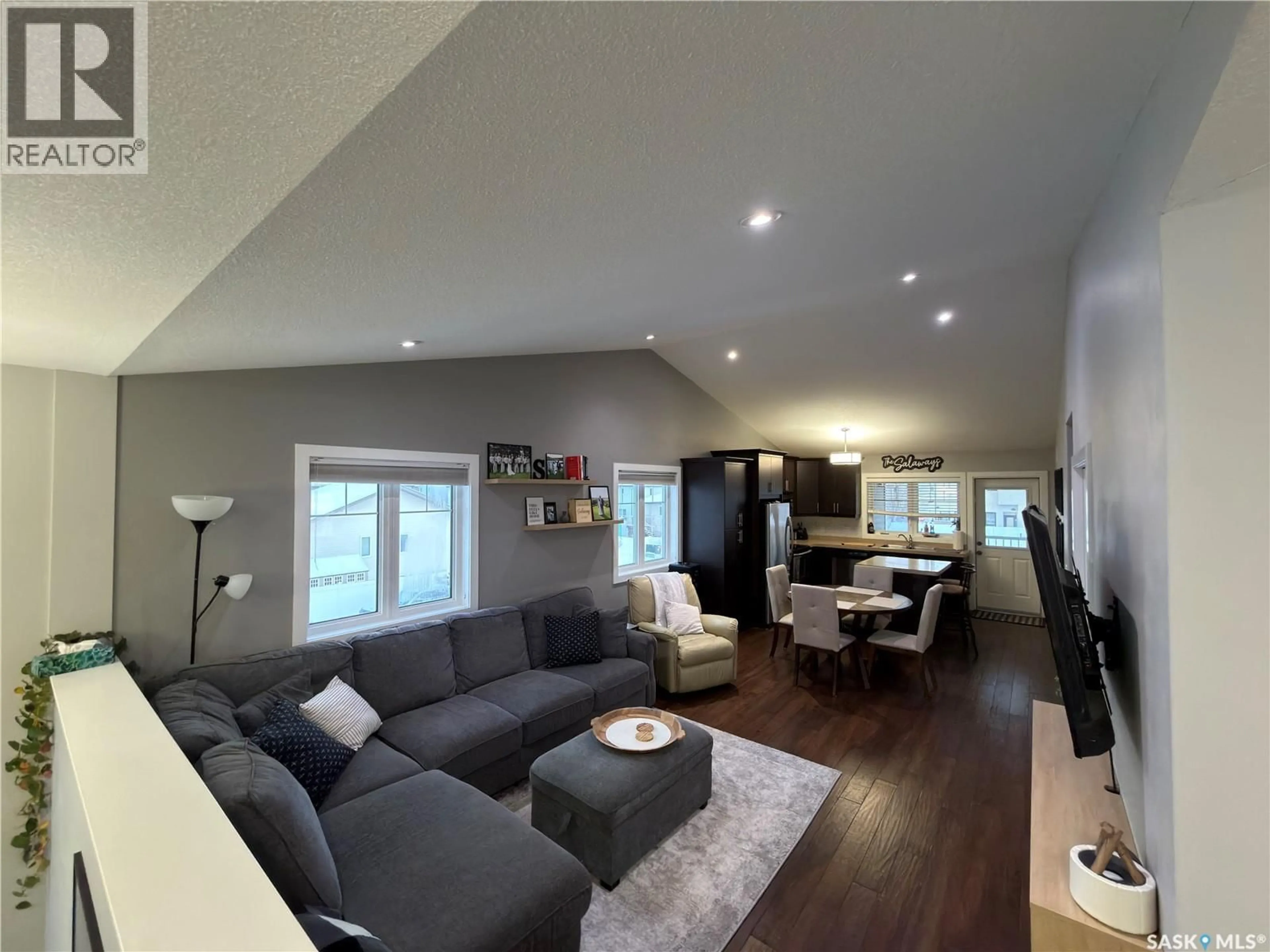 Living room with furniture, wood/laminate floor for E - 4247 GREEN APPLE DRIVE, Regina Saskatchewan S4V1S1