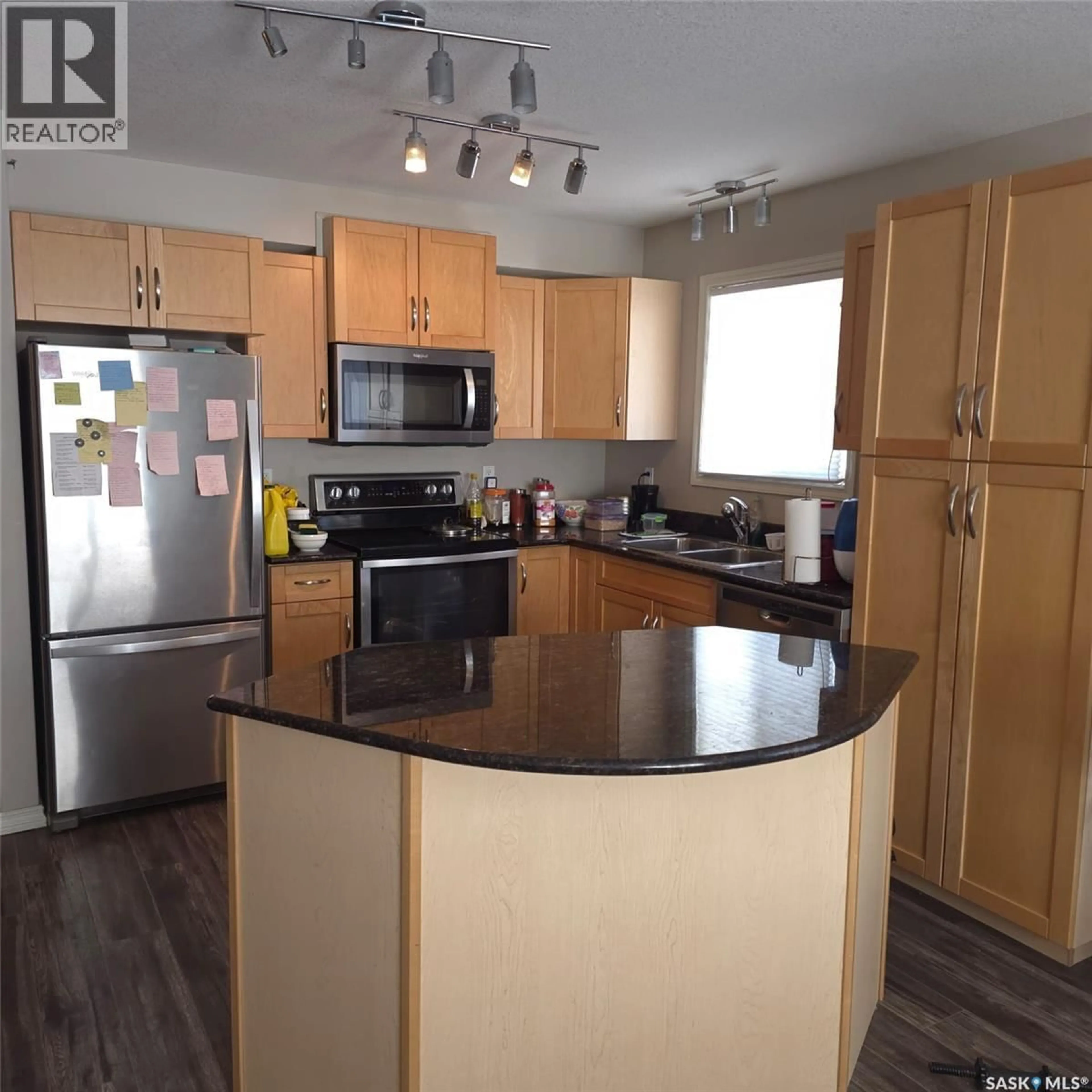 Open concept kitchen, wood/laminate floor for 316 326 HEROLD ROAD, Saskatoon Saskatchewan S7V0A2