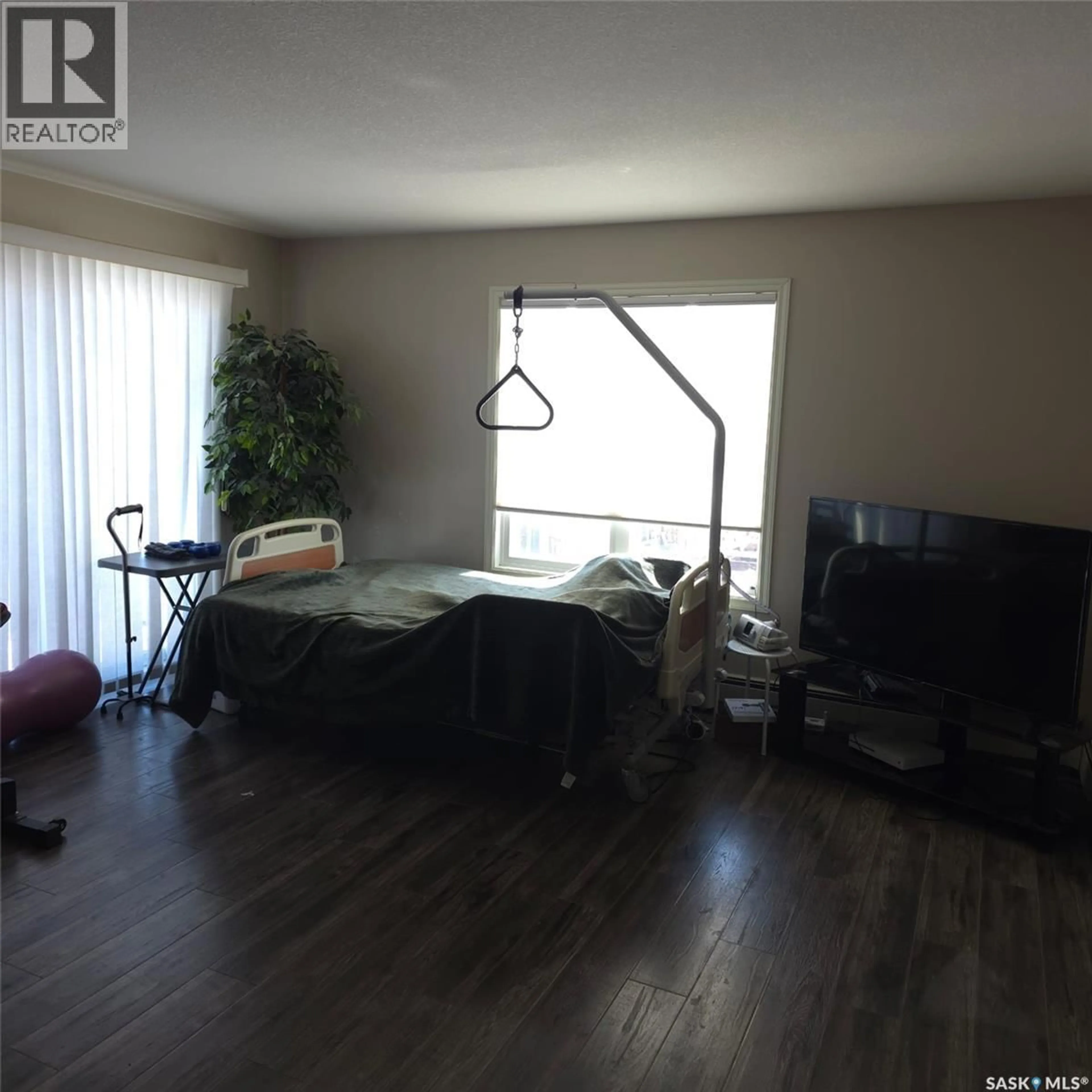 Living room with furniture, wood/laminate floor for 316 326 HEROLD ROAD, Saskatoon Saskatchewan S7V0A2