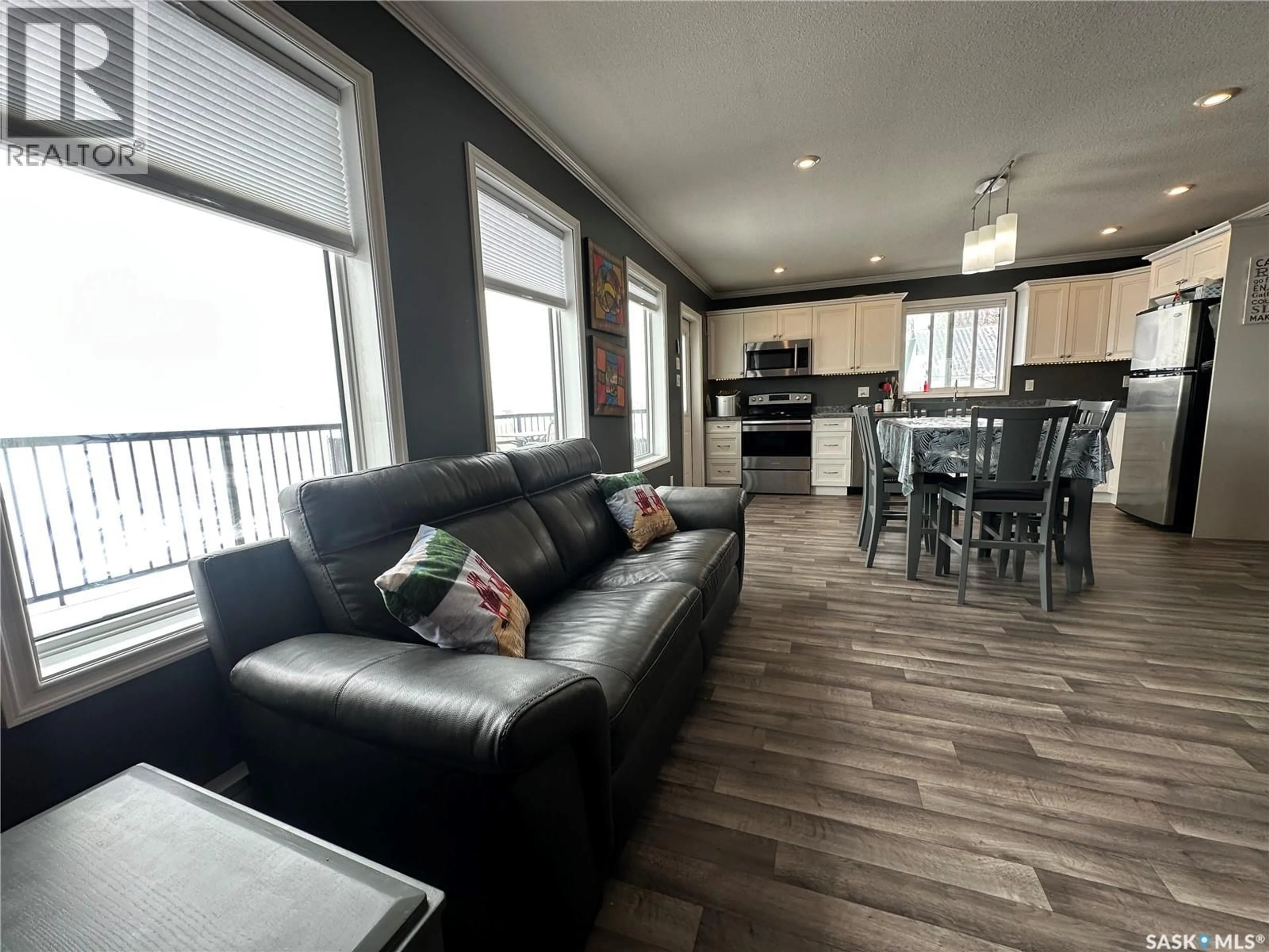 Living room with furniture, wood/laminate floor for 825 PARK DRIVE, Good Lake Rm No. 274 Saskatchewan S0A0L0