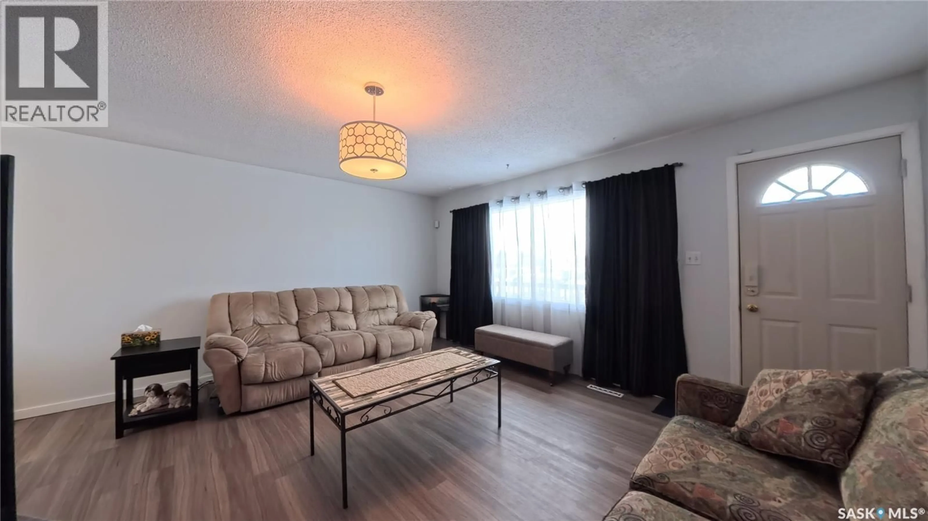 Living room with furniture, wood/laminate floor for 105 113TH STREET, Saskatoon Saskatchewan S7N1V8