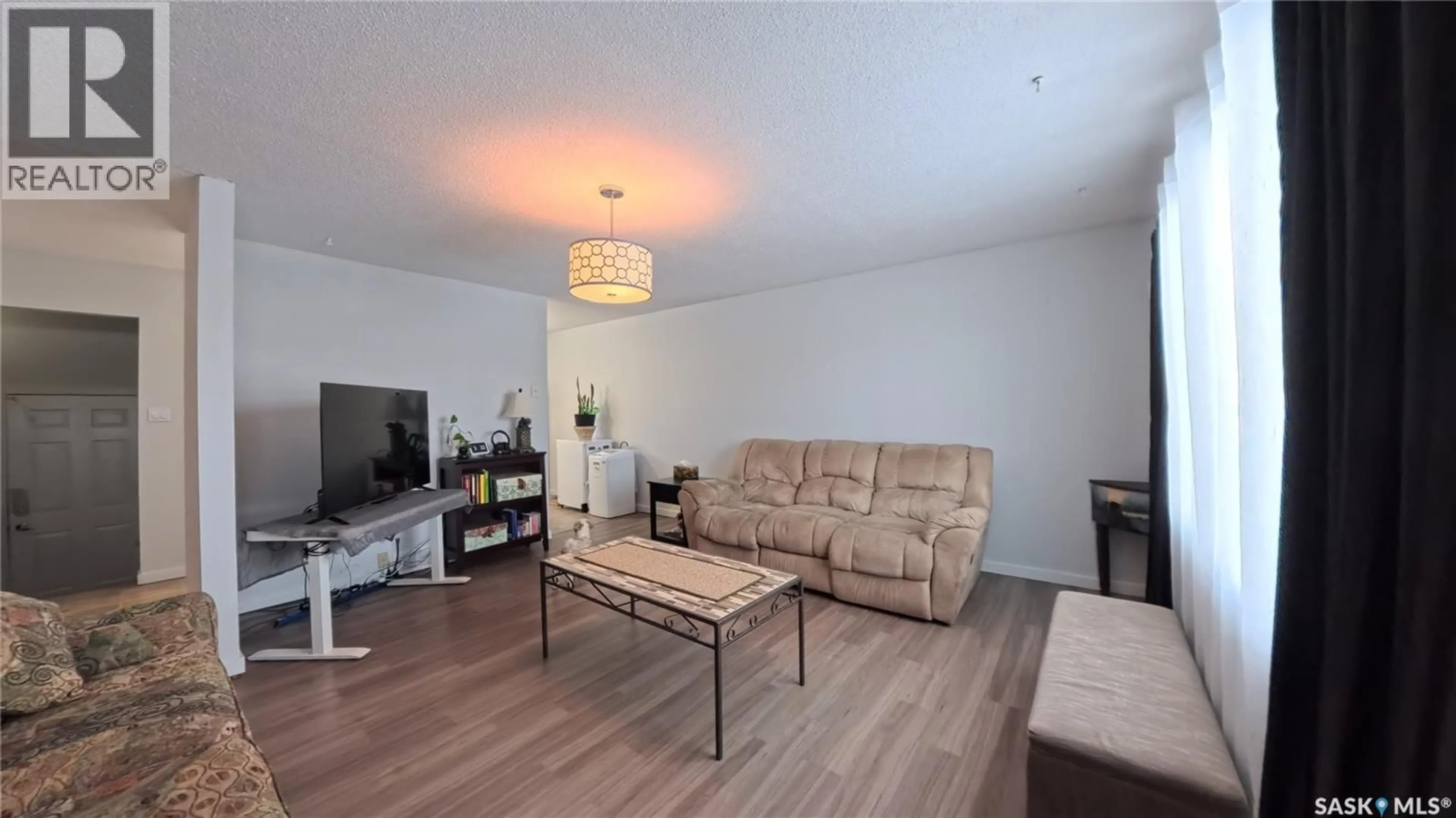 Living room with furniture, wood/laminate floor for 105 113TH STREET, Saskatoon Saskatchewan S7N1V8