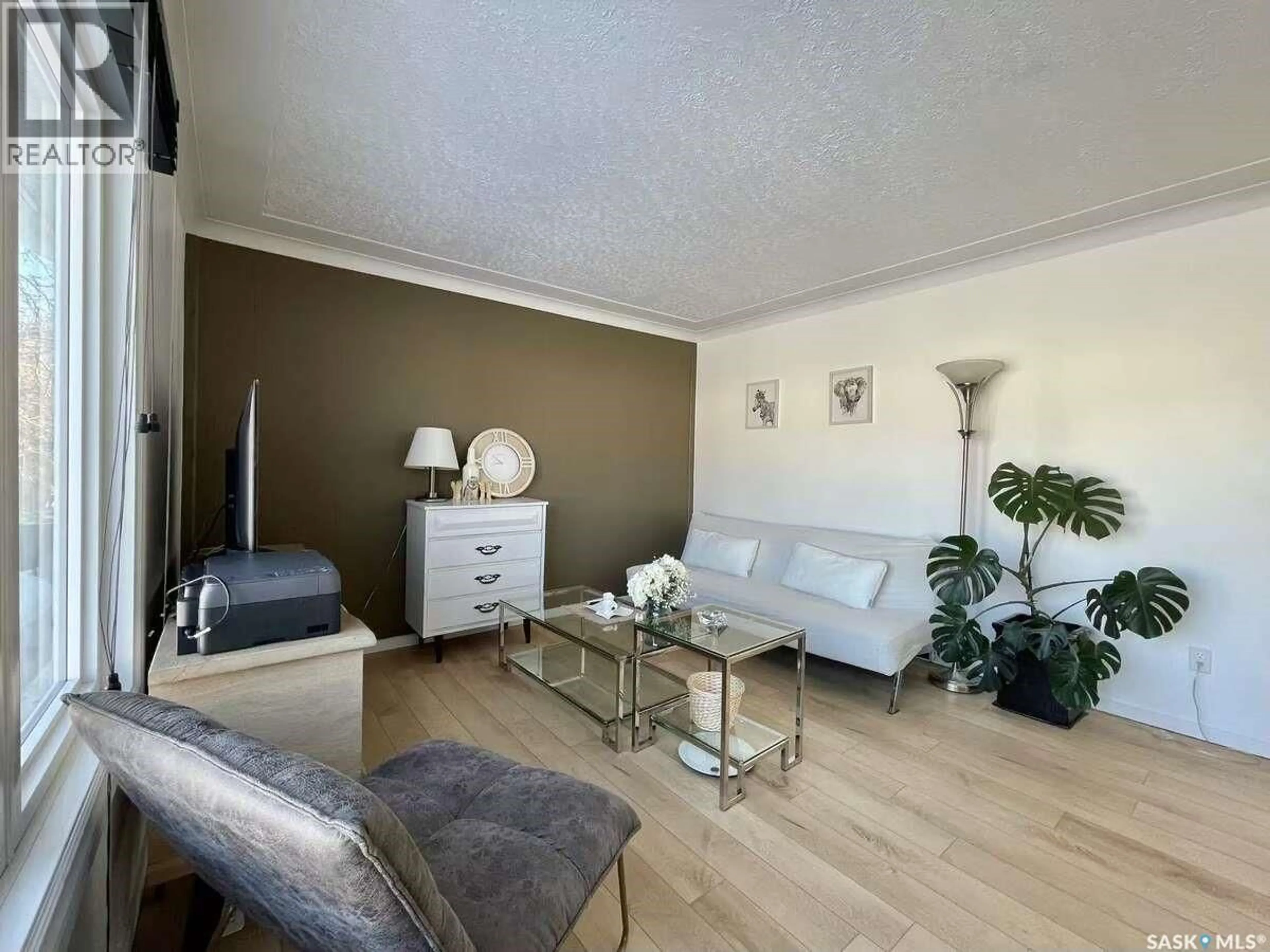 Living room with furniture, wood/laminate floor for 7227 6TH AVENUE, Regina Saskatchewan S4T0P3