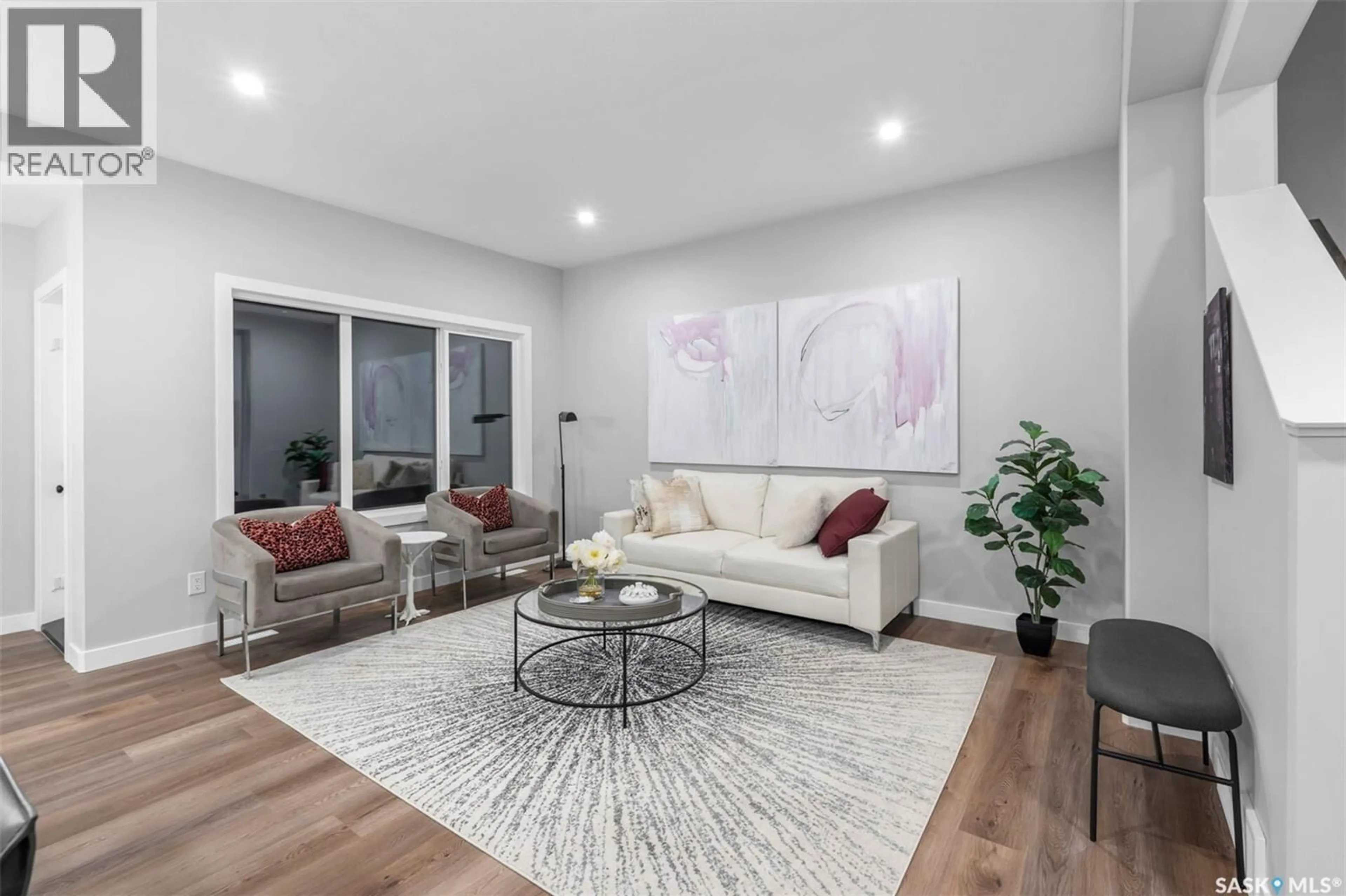 Living room with furniture, wood/laminate floor for 4968 PADWICK ROAD, Regina Saskatchewan S4W0C3