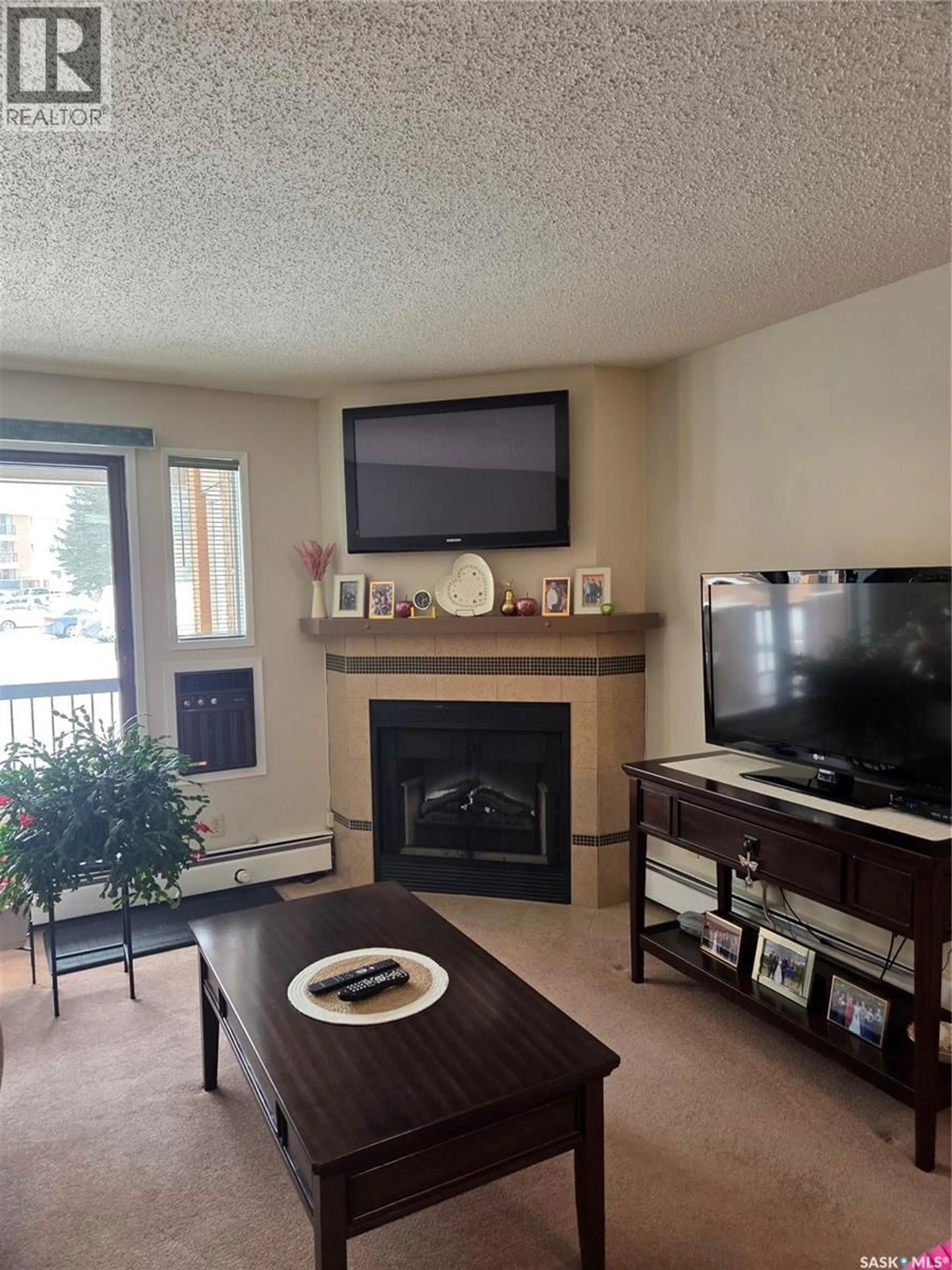 Living room with furniture, wood/laminate floor for 209A - 102 CREE PLACE, Saskatoon Saskatchewan S7K7Y9