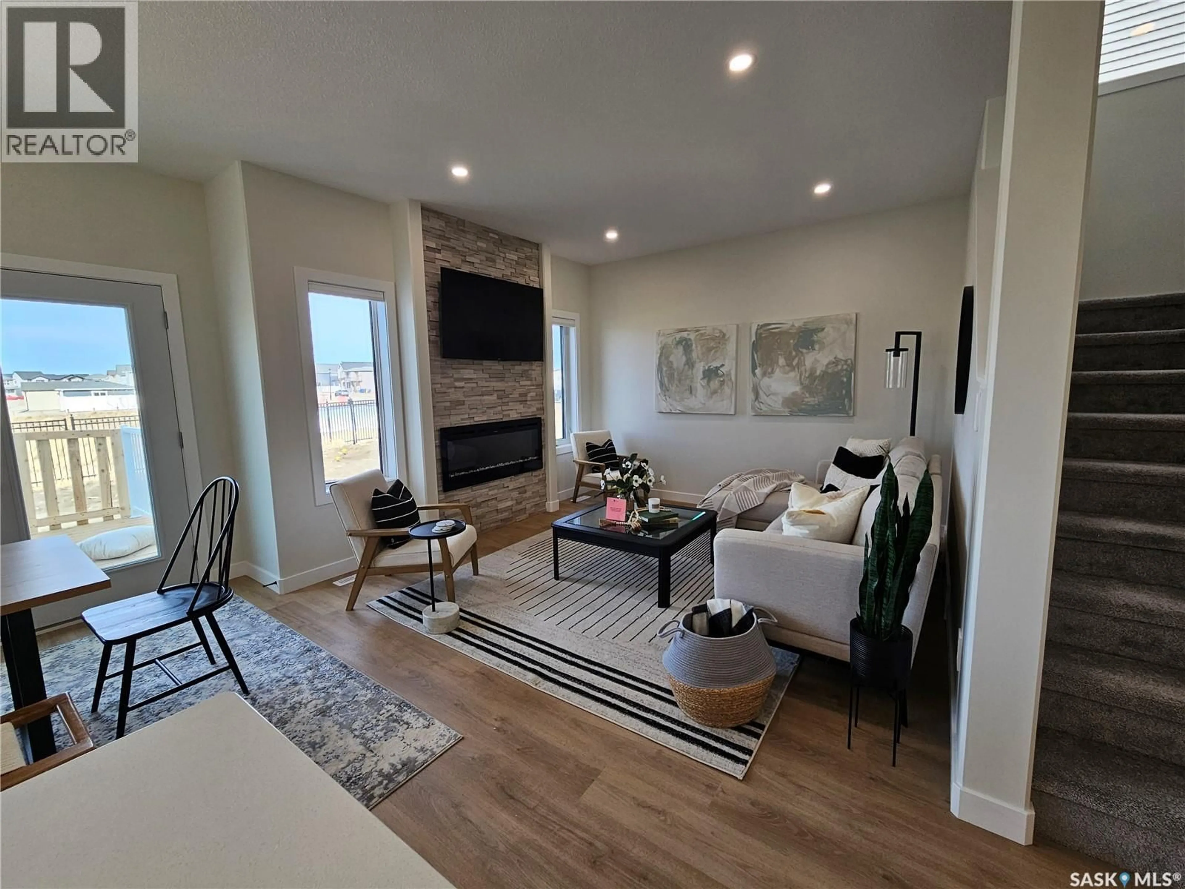 Living room with furniture, wood/laminate floor for 4964 PADWICK ROAD, Regina Saskatchewan S4W0C4