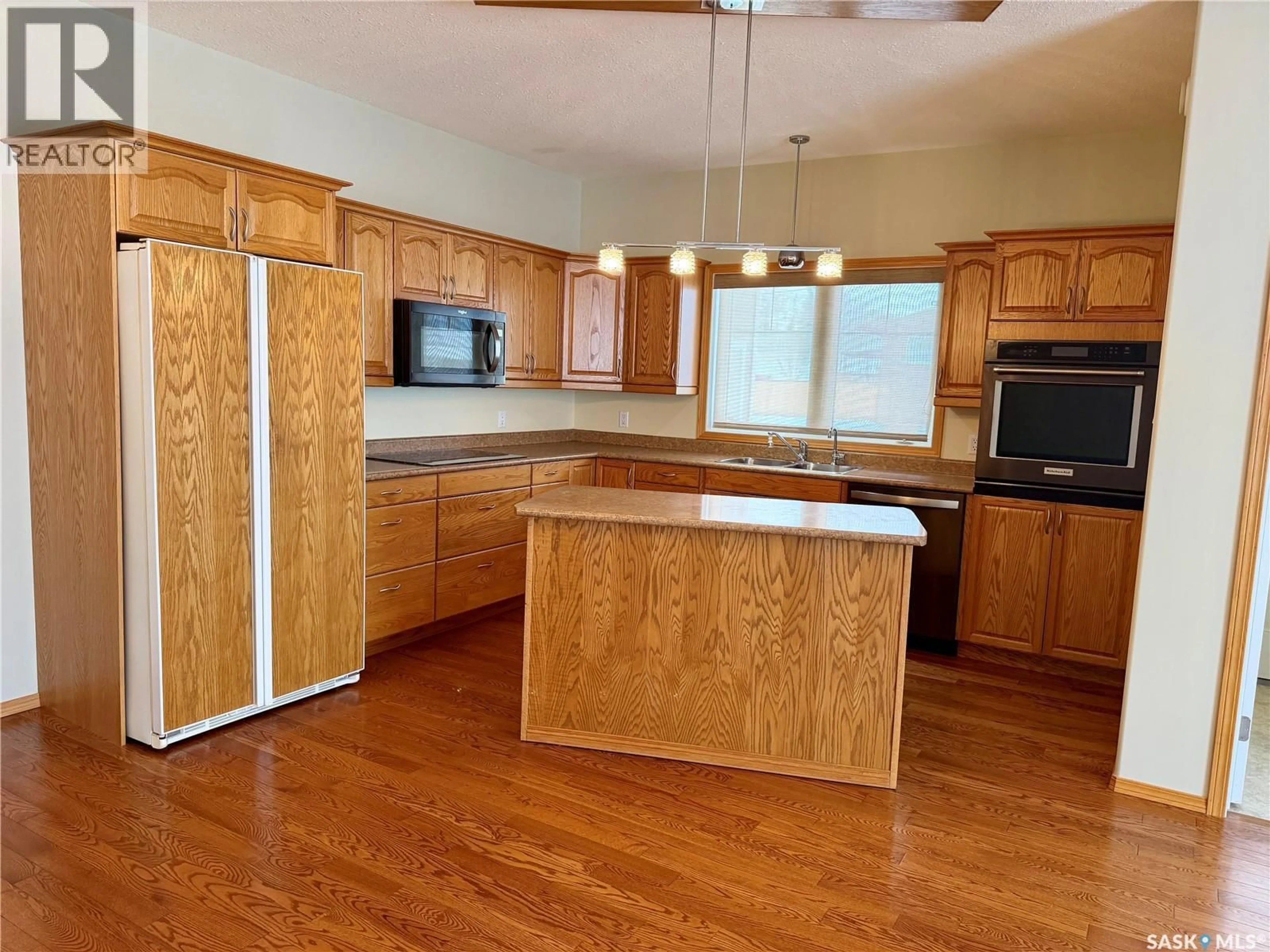 Open concept kitchen, wood/laminate floor for 330 1ST STREET, Spiritwood Saskatchewan S0J2M0