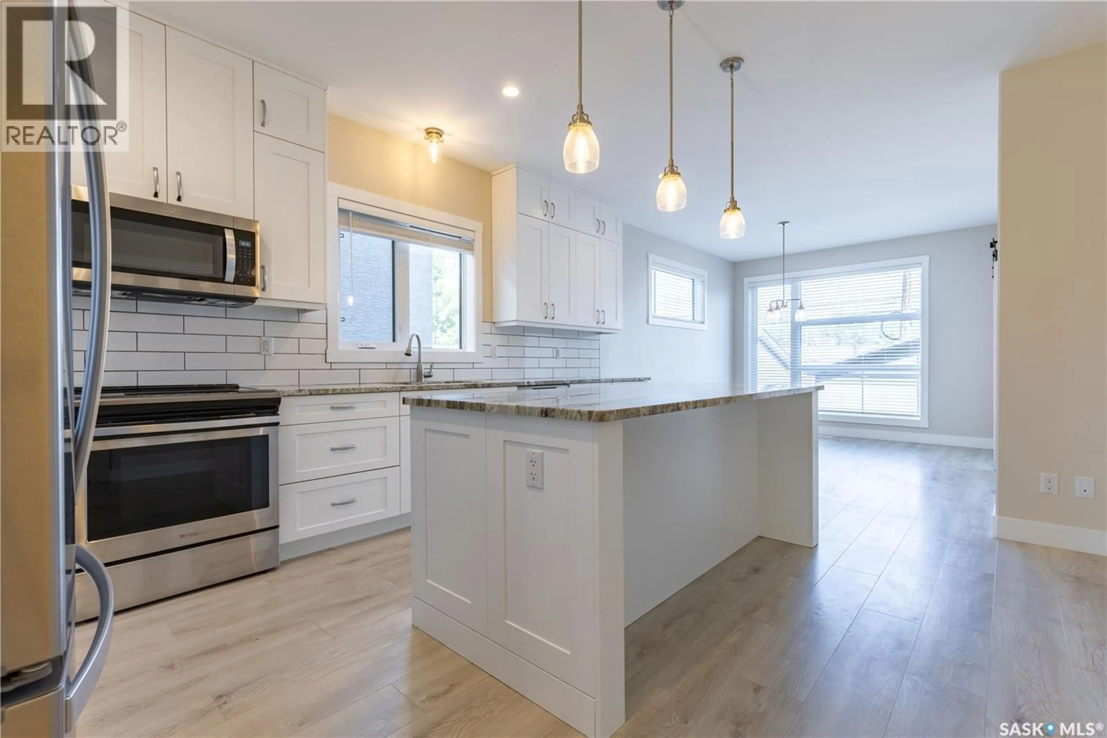 Open concept kitchen, wood/laminate floor for 1037 7TH STREET, Saskatoon Saskatchewan S7H0Y7