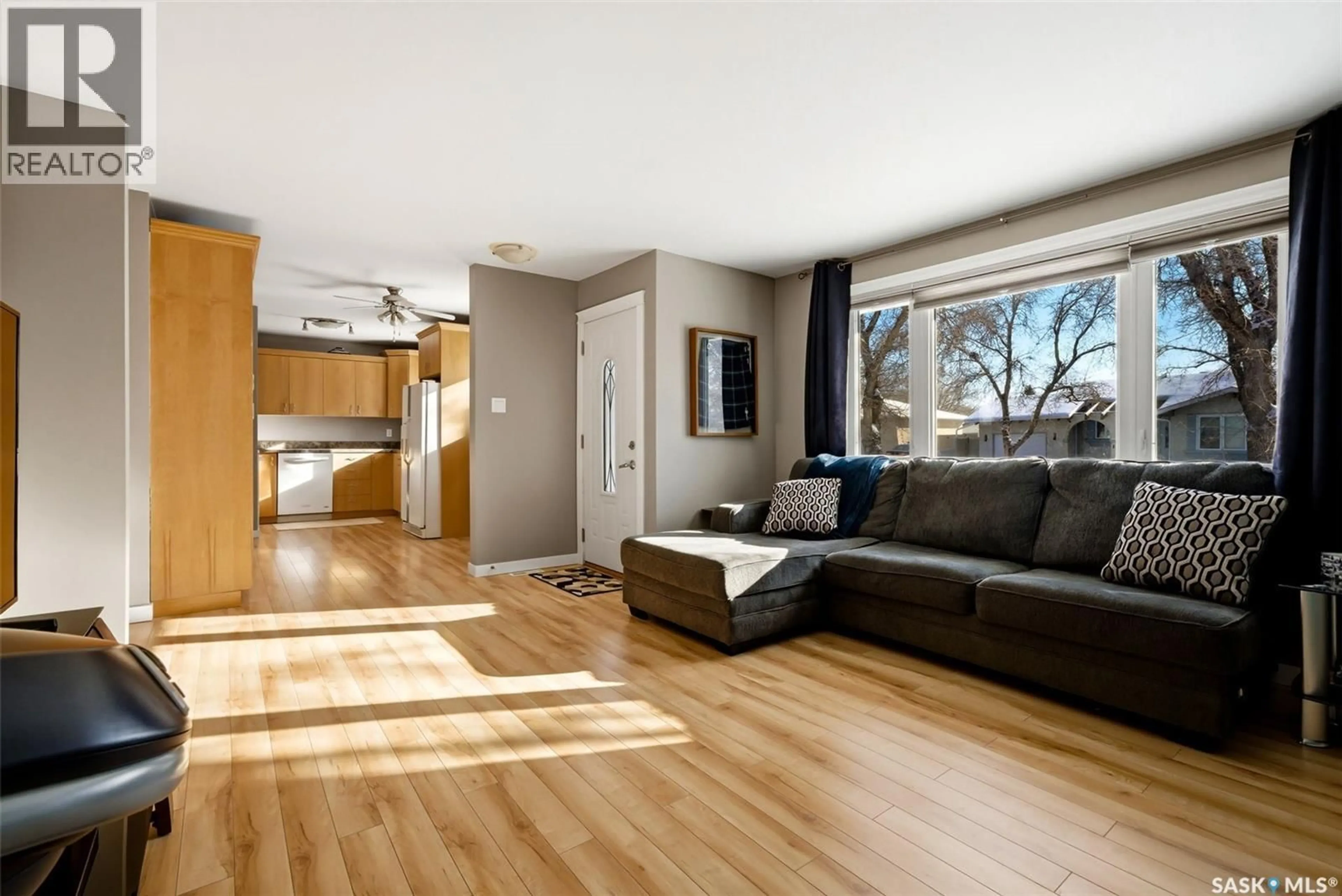 Living room with furniture, wood/laminate floor for 22 SIBBALD CRESCENT, Regina Saskatchewan S4T7L7