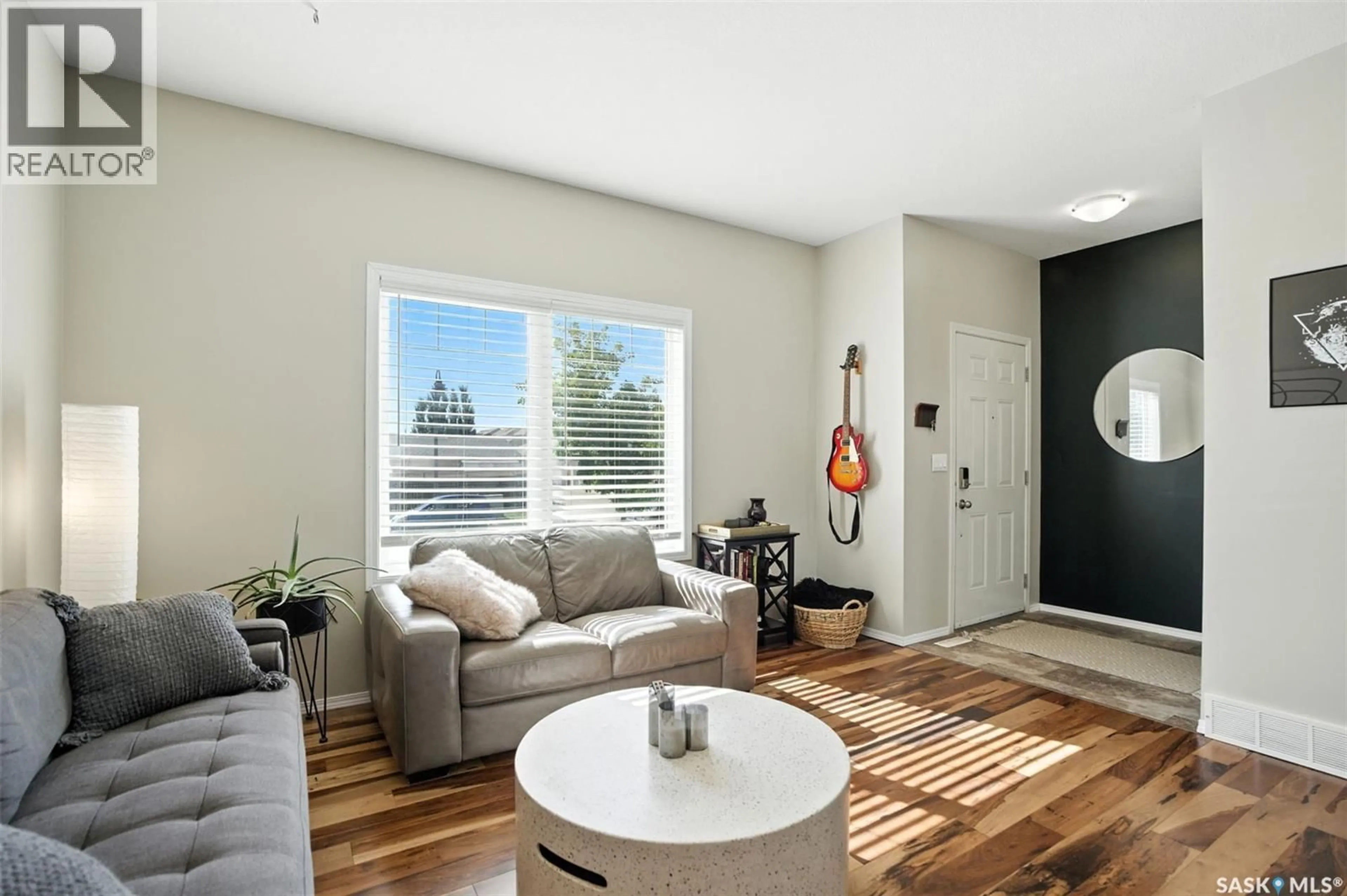 Living room with furniture, wood/laminate floor for 227 GALLOWAY ROAD, Saskatoon Saskatchewan S7T0B2