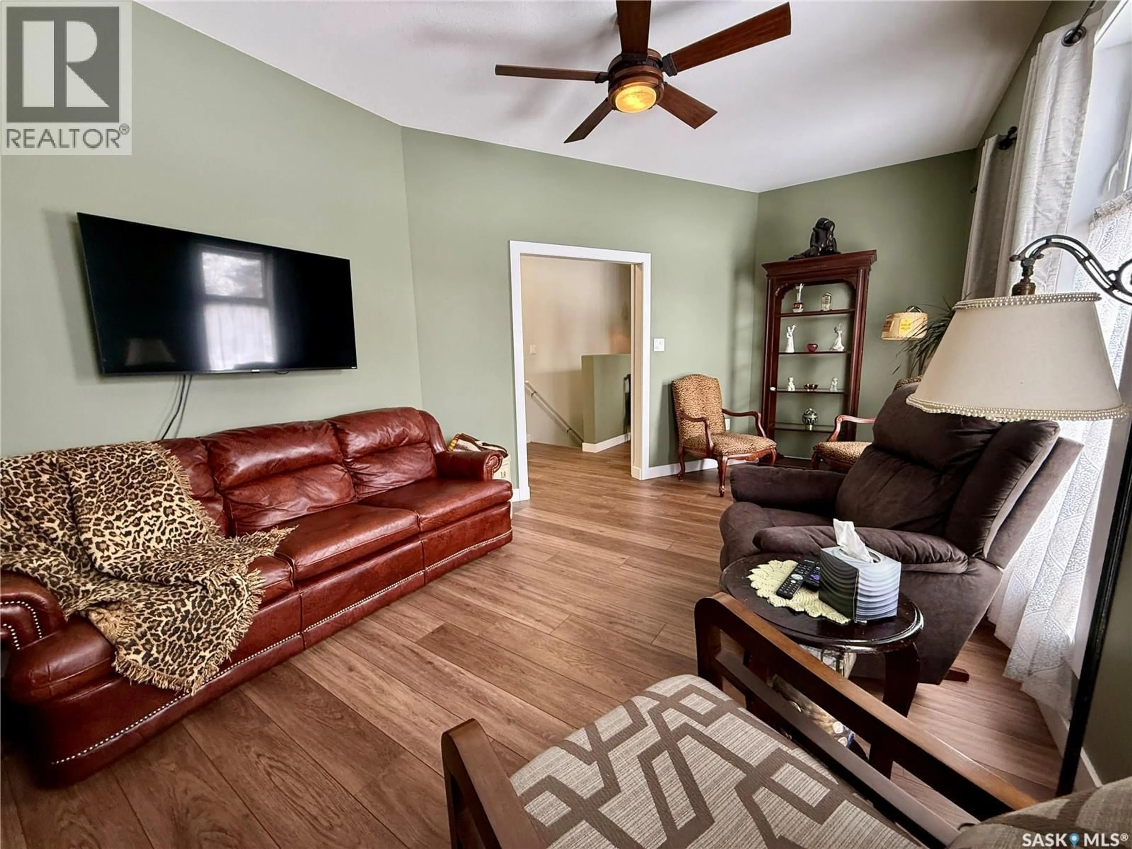 Living room with furniture, wood/laminate floor for 742 99TH STREET, North Battleford Saskatchewan S9A0N9