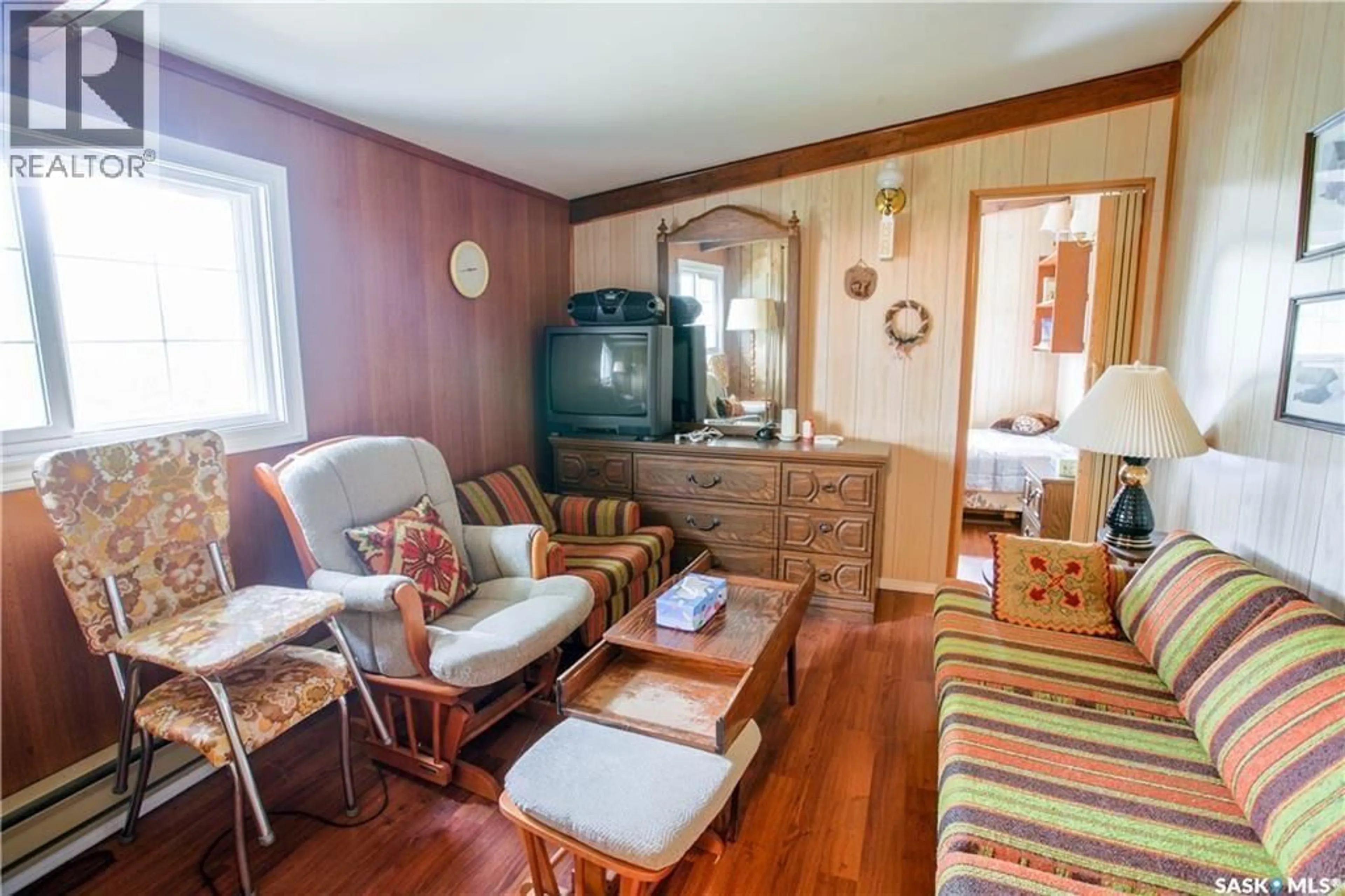 Living room with furniture, wood/laminate floor for 424 LAST MOUNTAIN ROAD, Mckillop Rm No. 220 Saskatchewan S0G4L0
