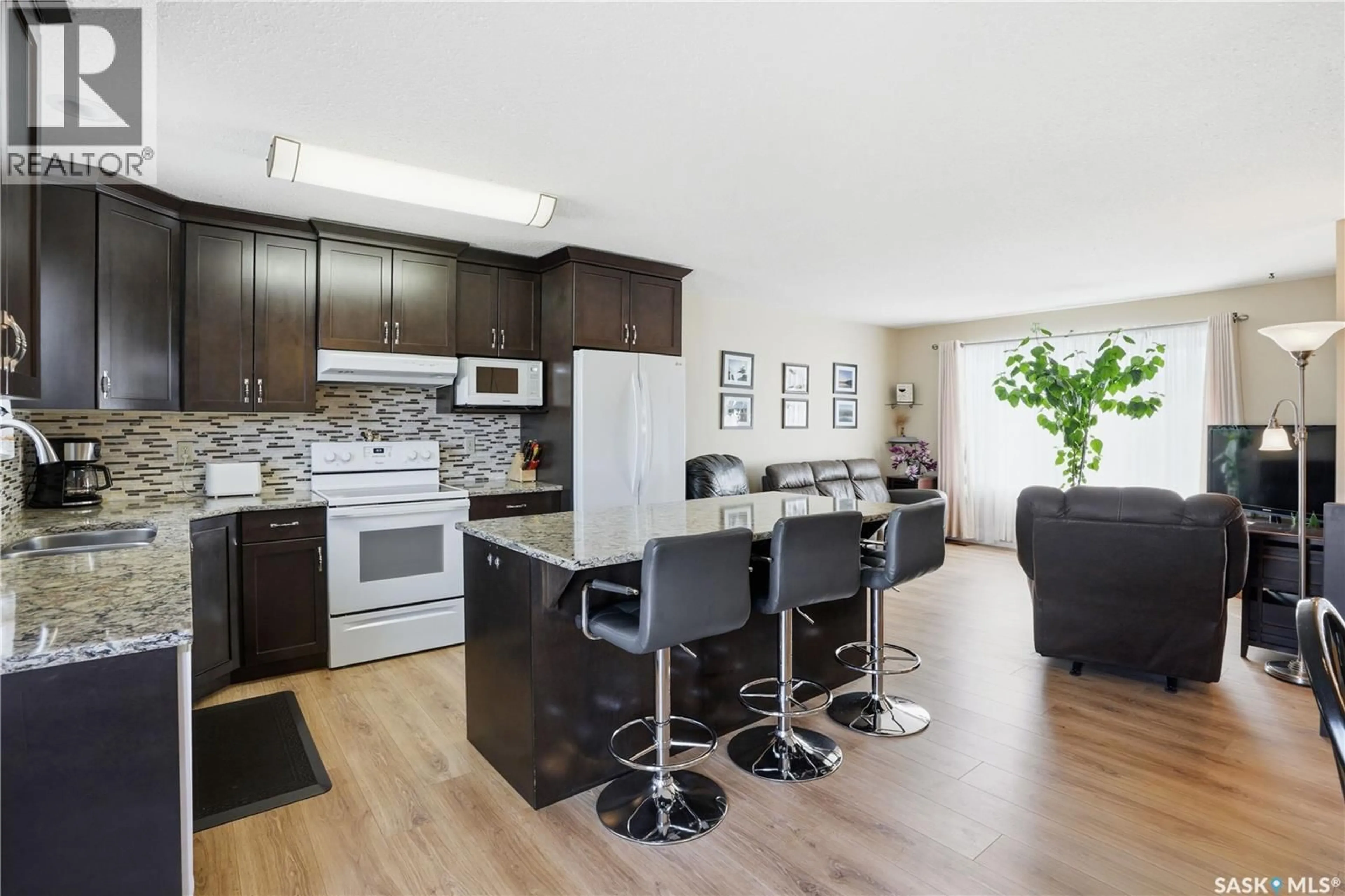 Open concept kitchen, wood/laminate floor for 425 5TH STREET, Martensville Saskatchewan S0K2T0