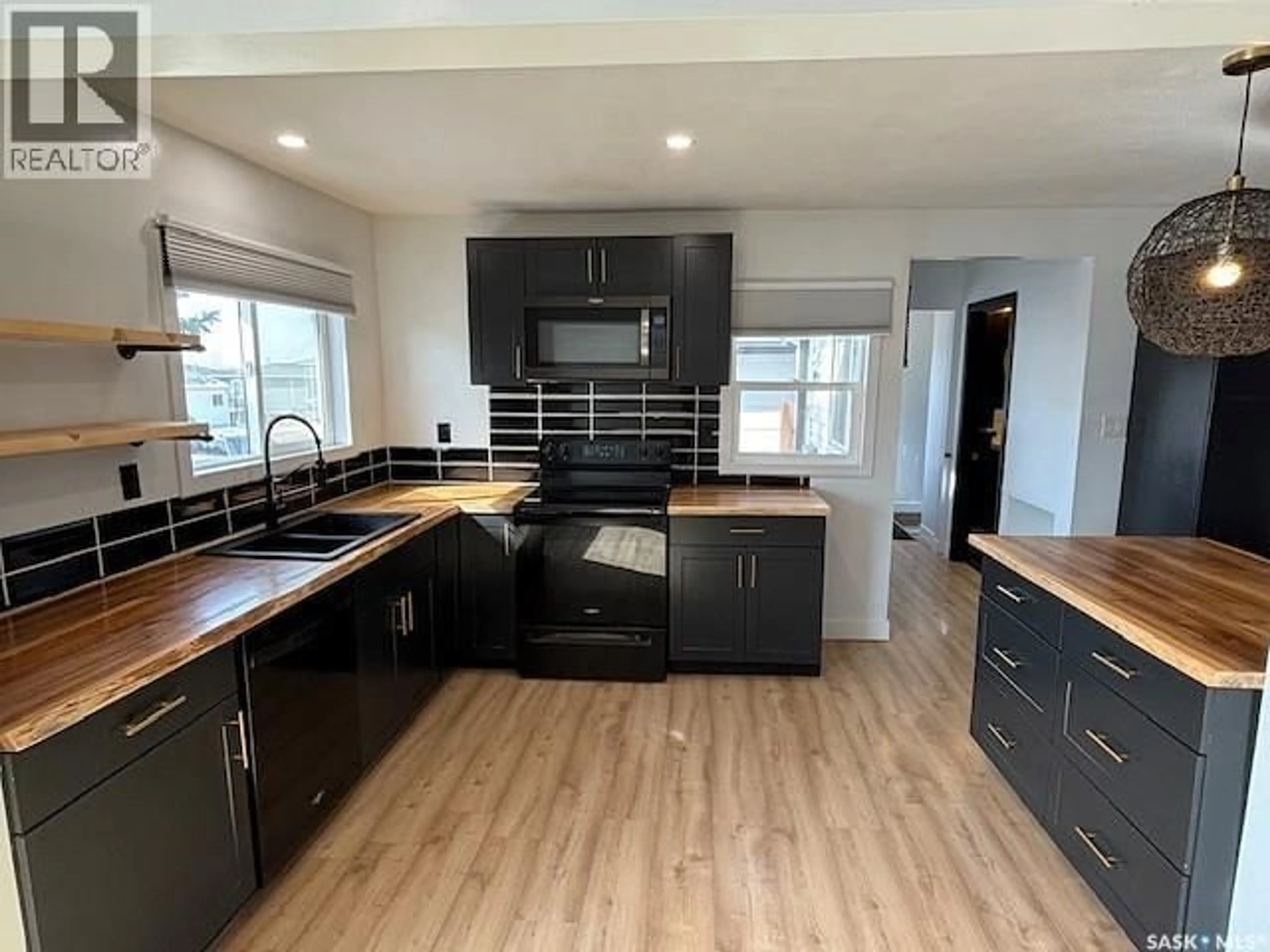 Open concept kitchen, wood/laminate floor for 1126 STADACONA STREET, Moose Jaw Saskatchewan S6H2B3