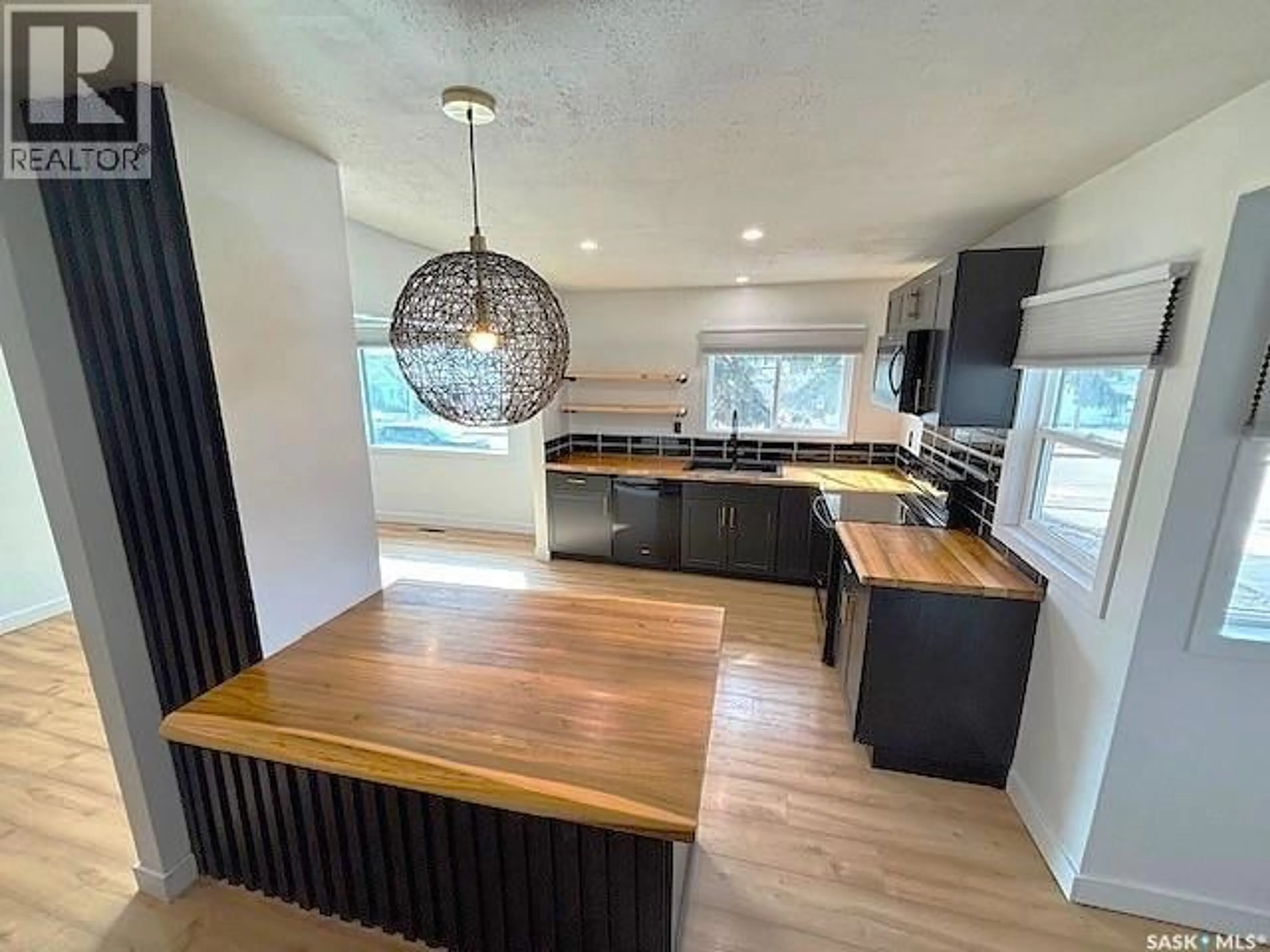 Open concept kitchen, wood/laminate floor for 1126 STADACONA STREET, Moose Jaw Saskatchewan S6H2B3