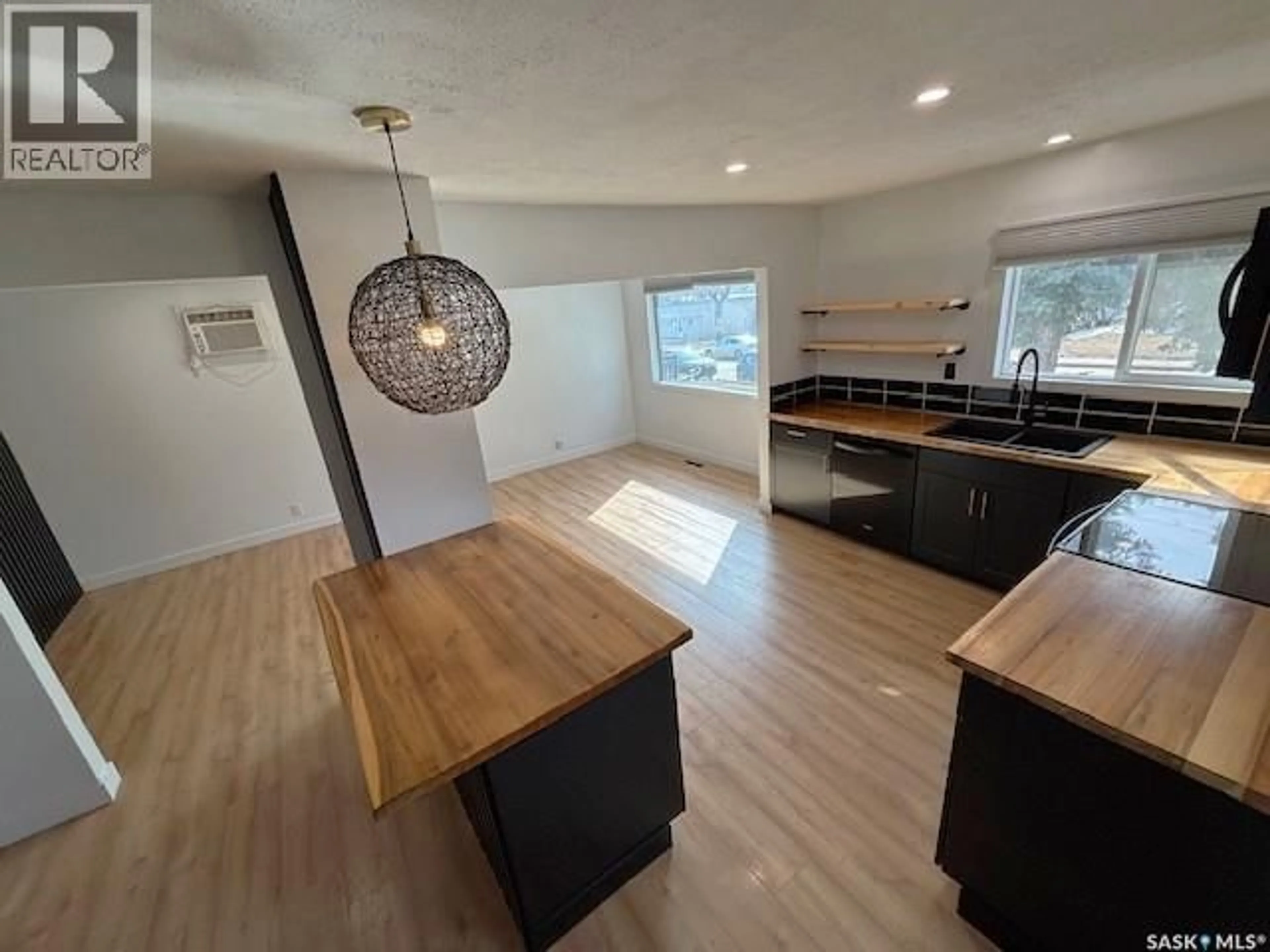 Open concept kitchen, wood/laminate floor for 1126 STADACONA STREET, Moose Jaw Saskatchewan S6H2B3