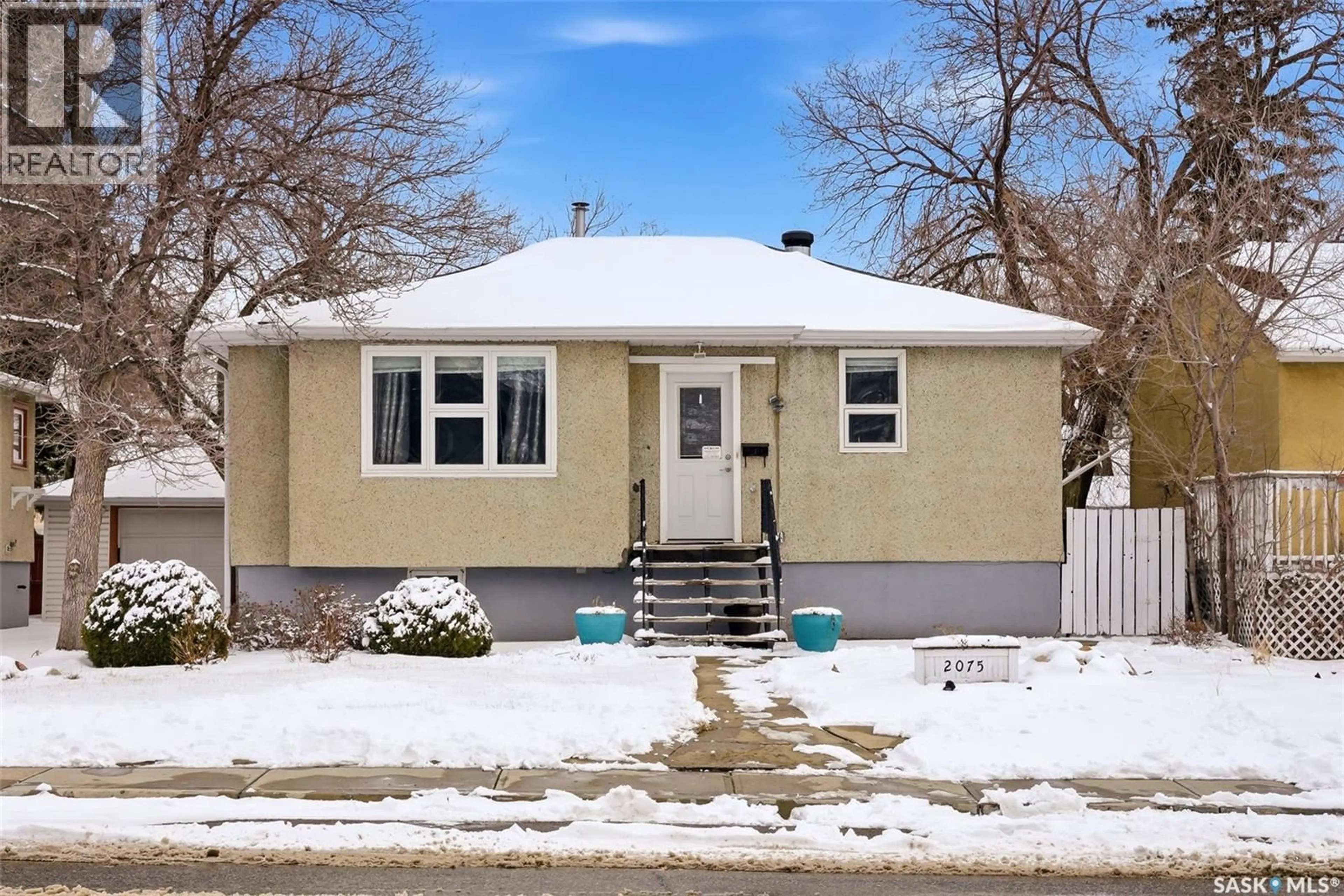 Home with vinyl exterior material, street for 2075 PASQUA STREET, Regina Saskatchewan S4T4M1